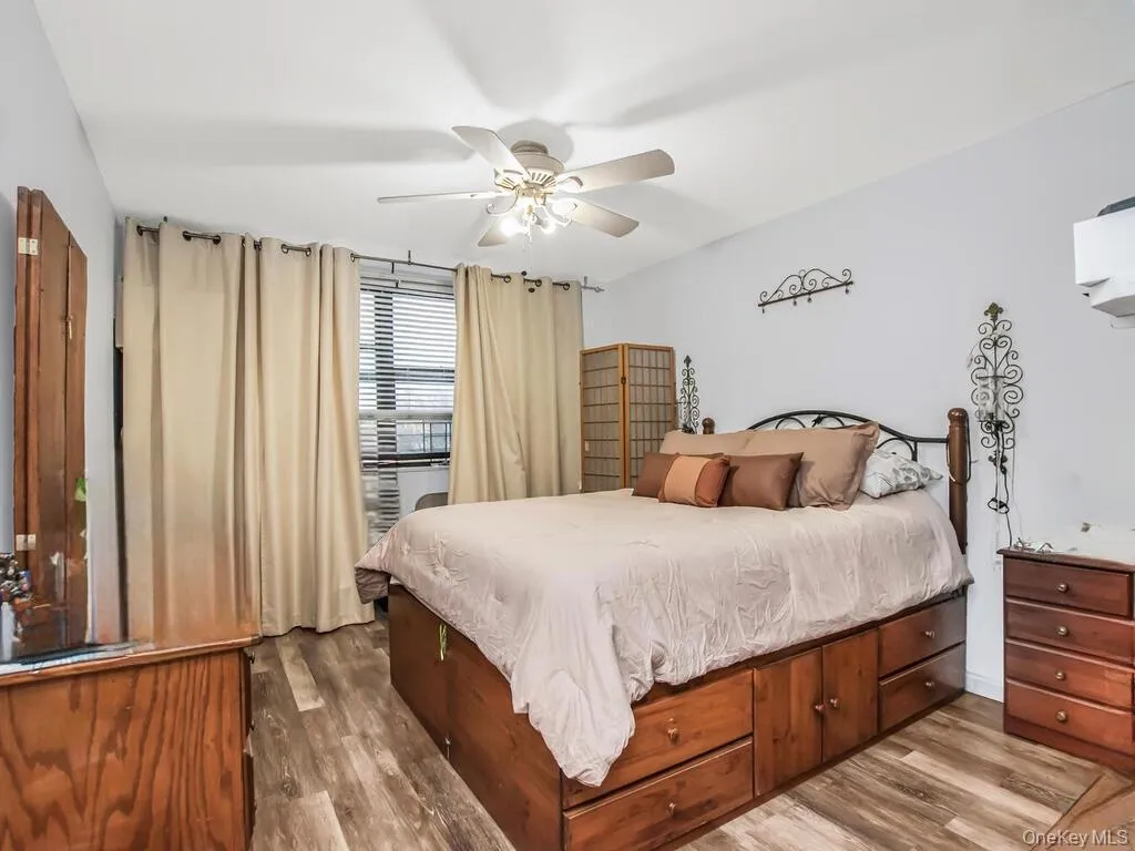 Bedroom featuring dark wood-style flooring and ceiling fan Bedroom featuring dark wood-style flooring and ceiling fan