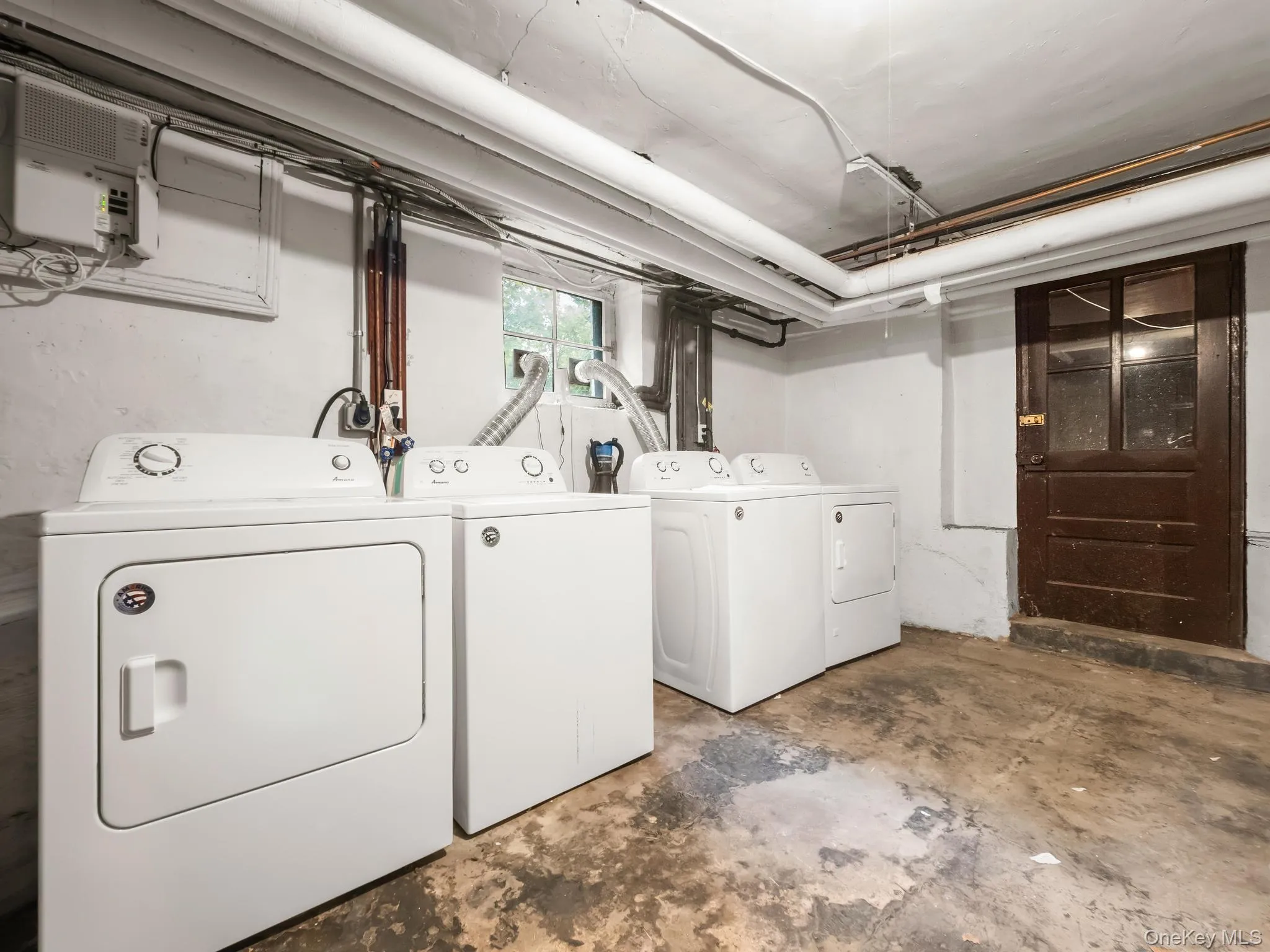 Laundry area with unfinished concrete floors and washer and dryer Laundry area with unfinished concrete floors and washer and dryer