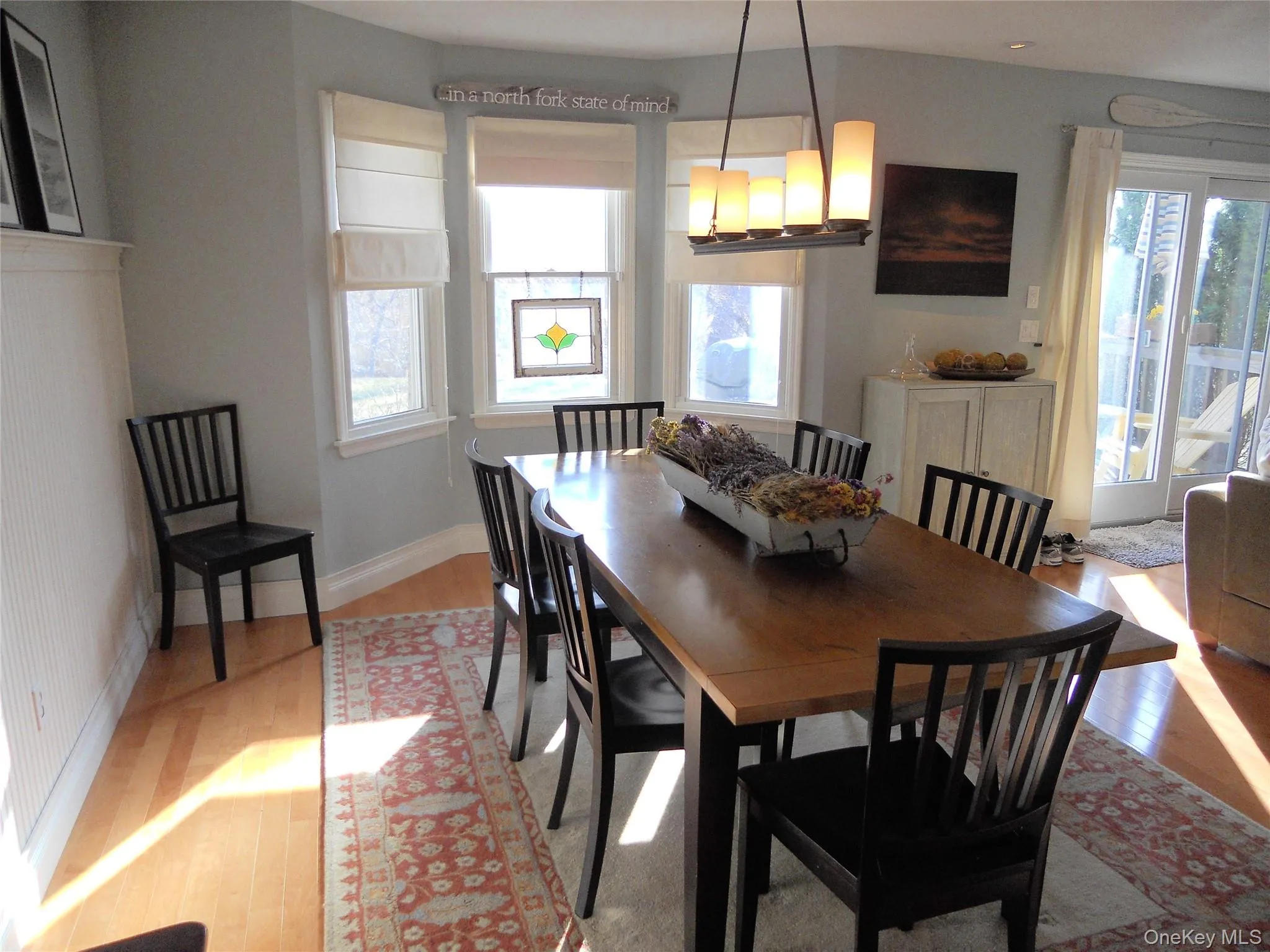 Dining area with light wood-style floors, plenty of natural light, and a chandelier Dining area with light wood-style floors, plenty of natural light, and a chandelier