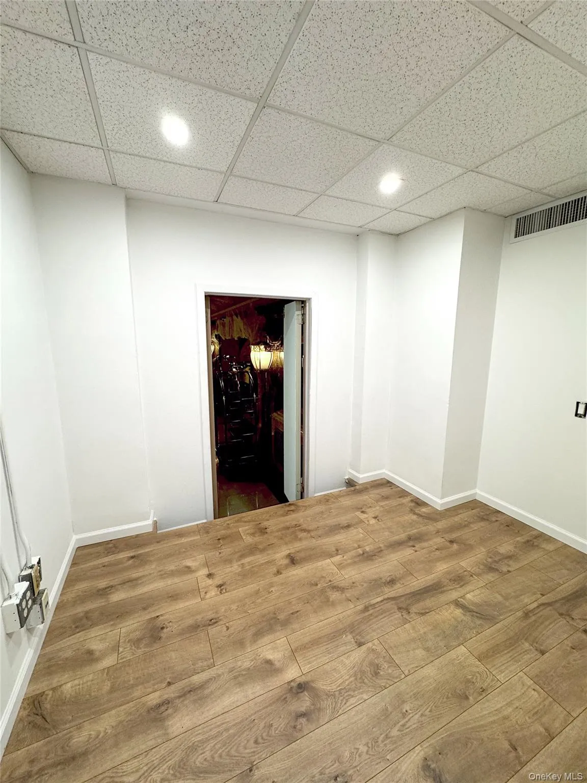 Unfurnished room featuring wood finished floors, recessed lighting, and a paneled ceiling Unfurnished room featuring wood finished floors, recessed lighting, and a paneled ceiling