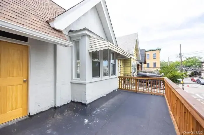 View of property exterior featuring roof with shingles and a balcony View of property exterior featuring roof with shingles and a balcony