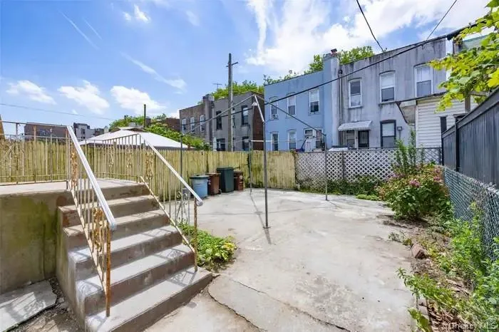 Fenced backyard with a patio area Fenced backyard with a patio area