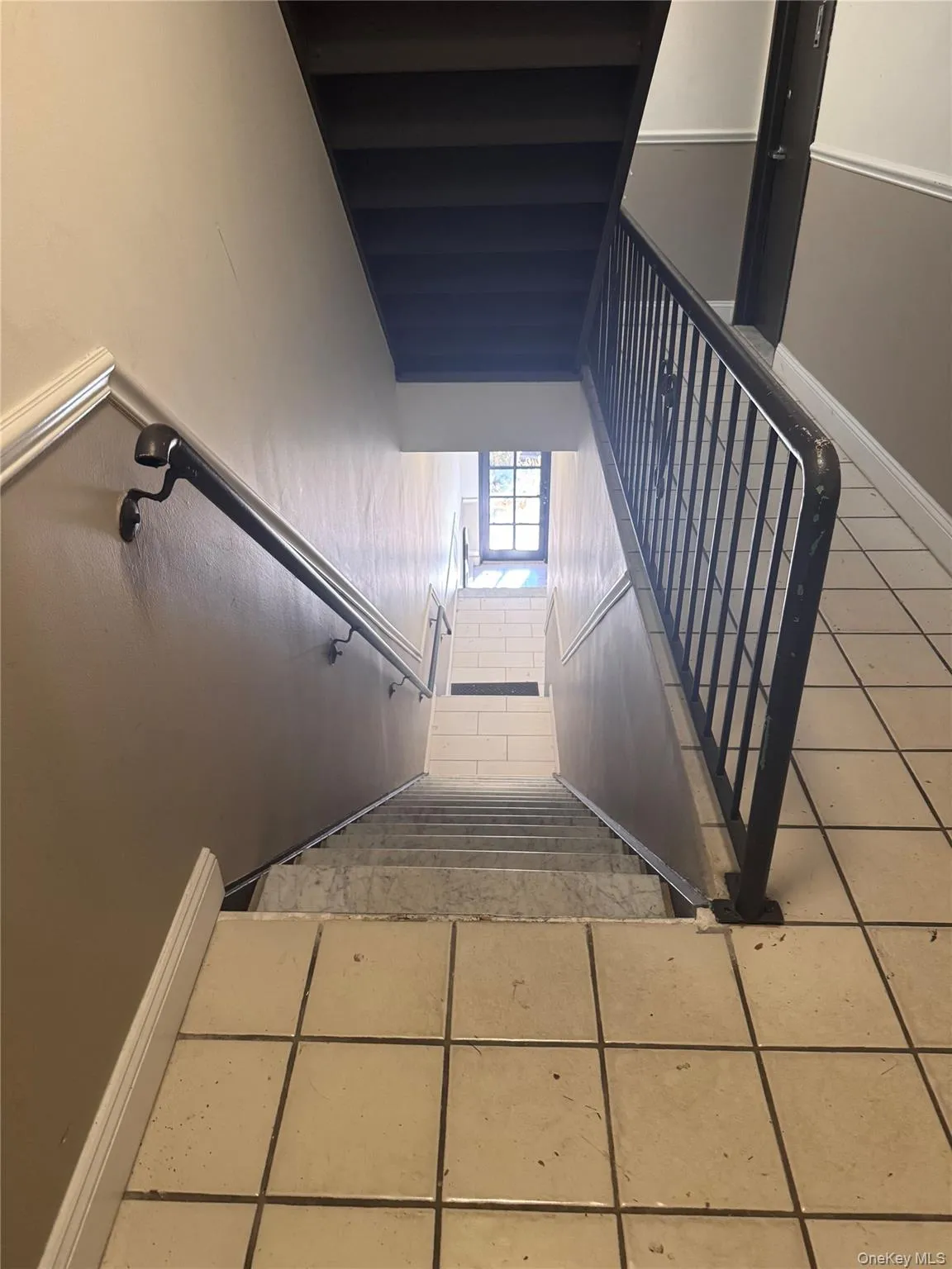 Stairway with tile patterned floors and baseboards Stairway with tile patterned floors and baseboards