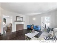 Living room featuring a fireplace and wood finished floors Living room featuring a fireplace and wood finished floors