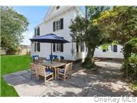 Rear view of house featuring a patio area, outdoor dining space, and a yard Rear view of house featuring a patio area, outdoor dining space, and a yard