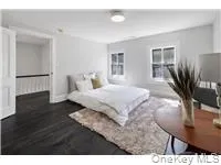 Bedroom featuring wood finished floors and baseboards Bedroom featuring wood finished floors and baseboards