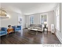 Living room featuring dark wood-type flooring and radiator heating unit Living room featuring dark wood-type flooring and radiator heating unit