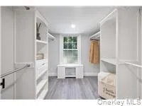Walk in closet with dark wood finished floors Walk in closet with dark wood finished floors