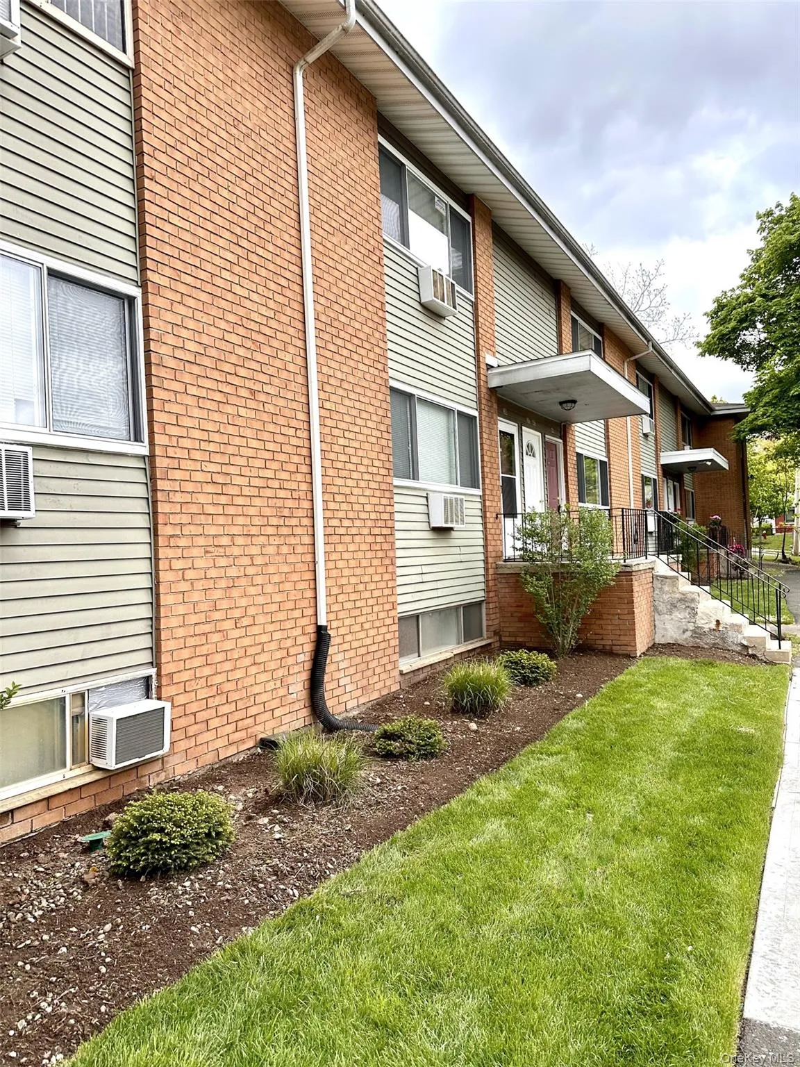 View of side of property with a lawn and brick siding View of side of property with a lawn and brick siding