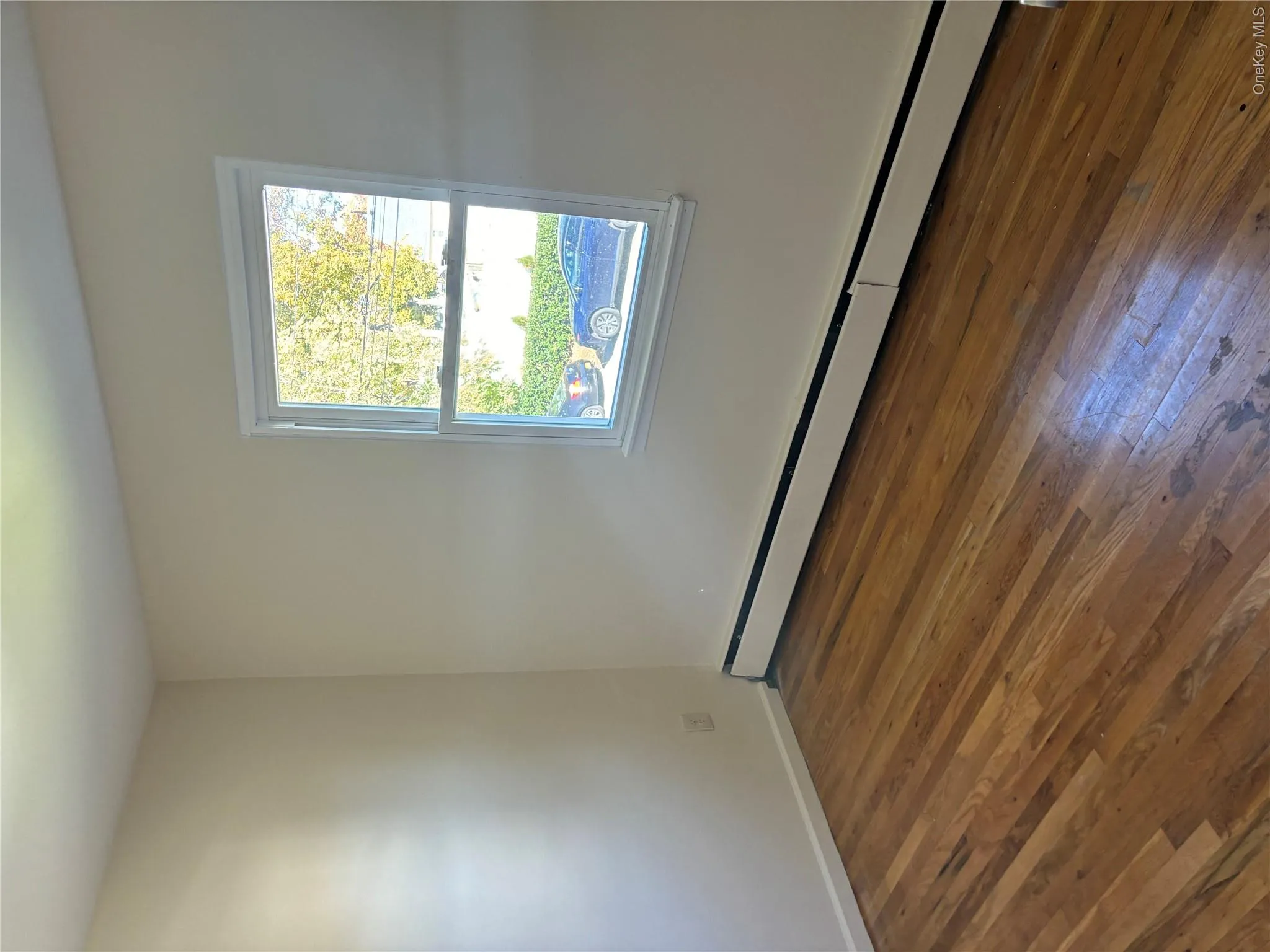 Spare room with baseboard heating and dark wood finished floors Spare room with baseboard heating and dark wood finished floors