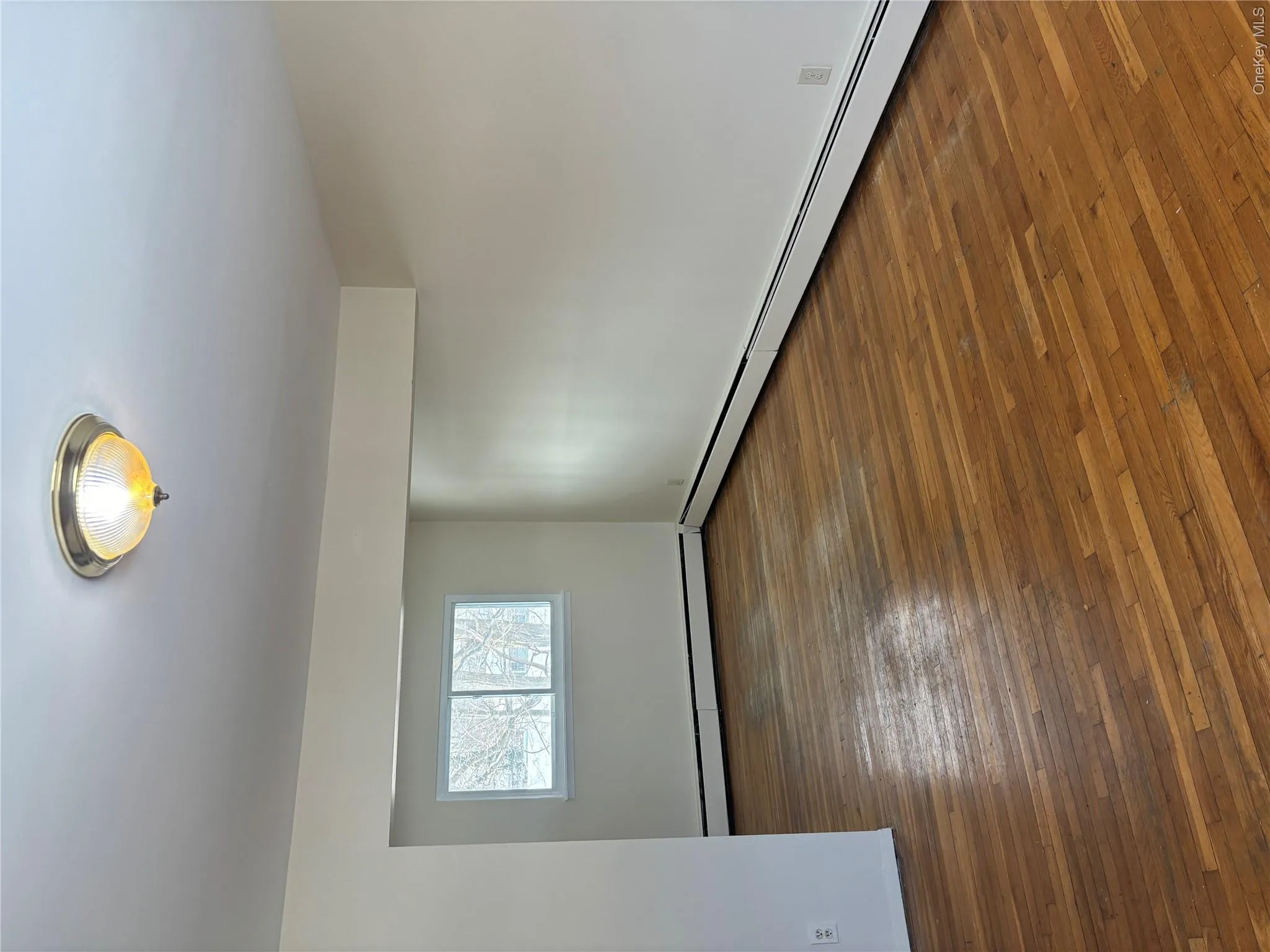 Spare room featuring dark wood-style floors and baseboard heating Spare room featuring dark wood-style floors and baseboard heating