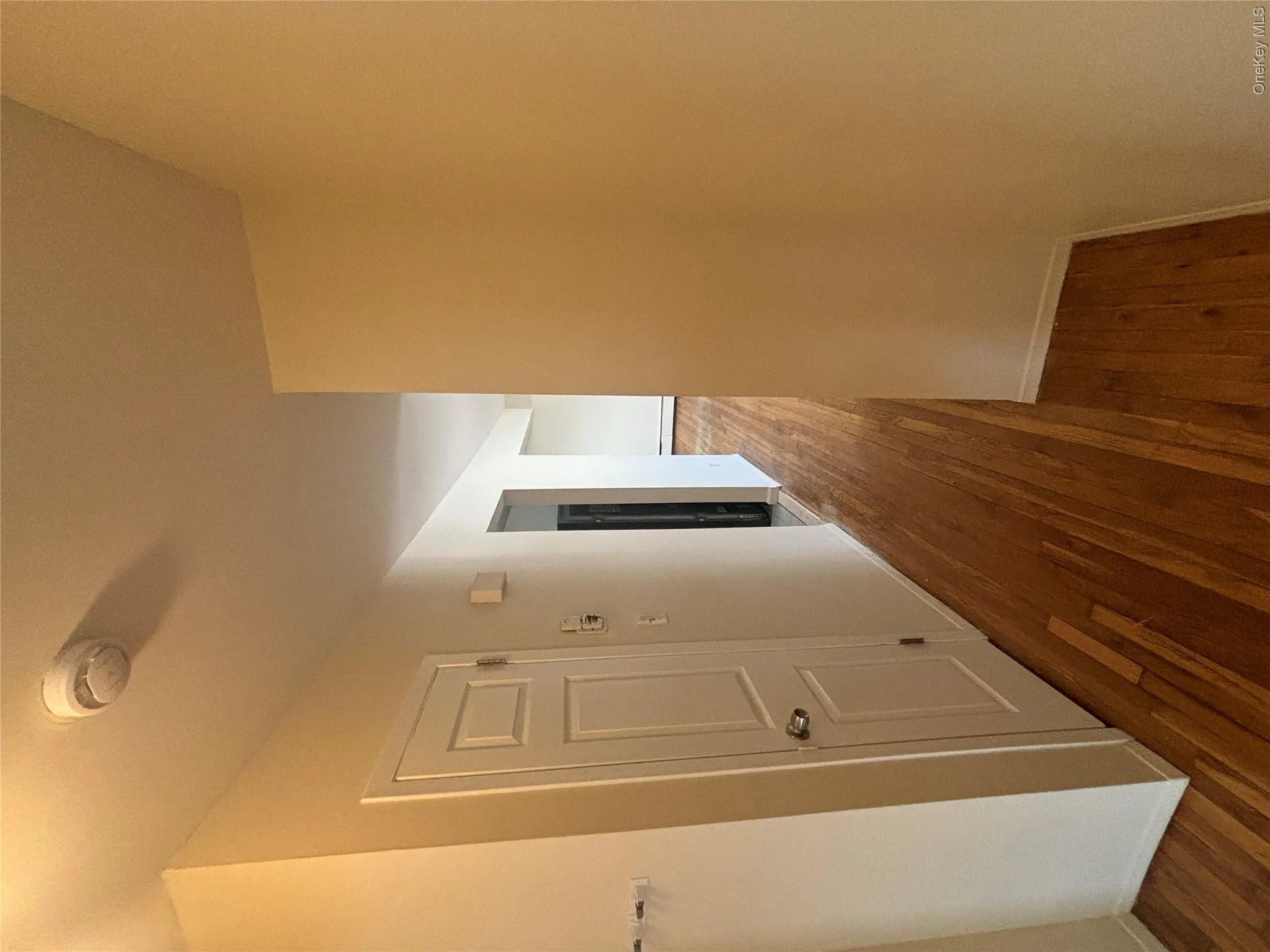 Corridor featuring dark wood finished floors and baseboards Corridor featuring dark wood finished floors and baseboards