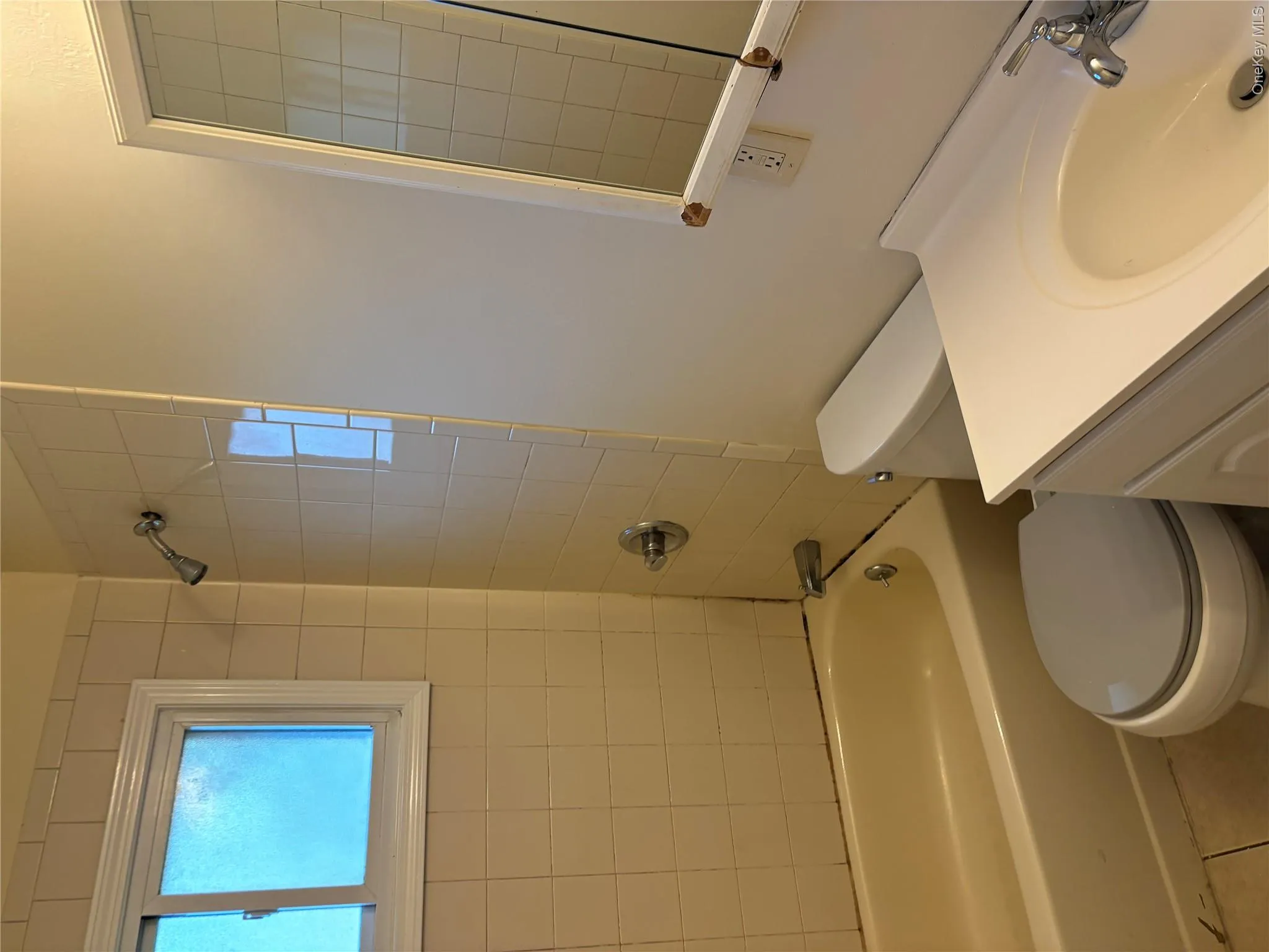 Bathroom with vanity, shower / washtub combination, and tile patterned flooring Bathroom with vanity, shower / washtub combination, and tile patterned flooring