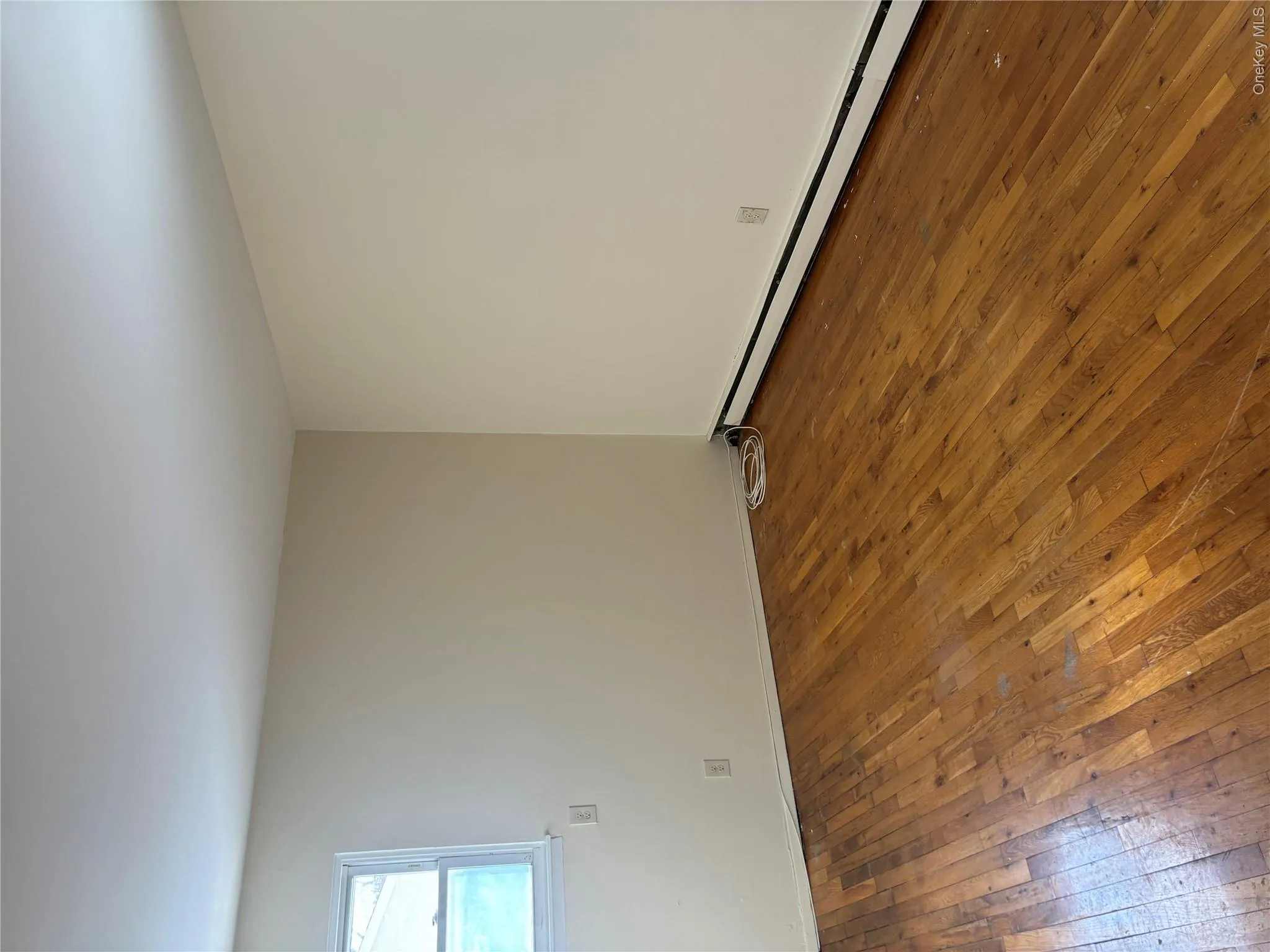 Spare room with dark wood finished floors and a baseboard radiator Spare room with dark wood finished floors and a baseboard radiator