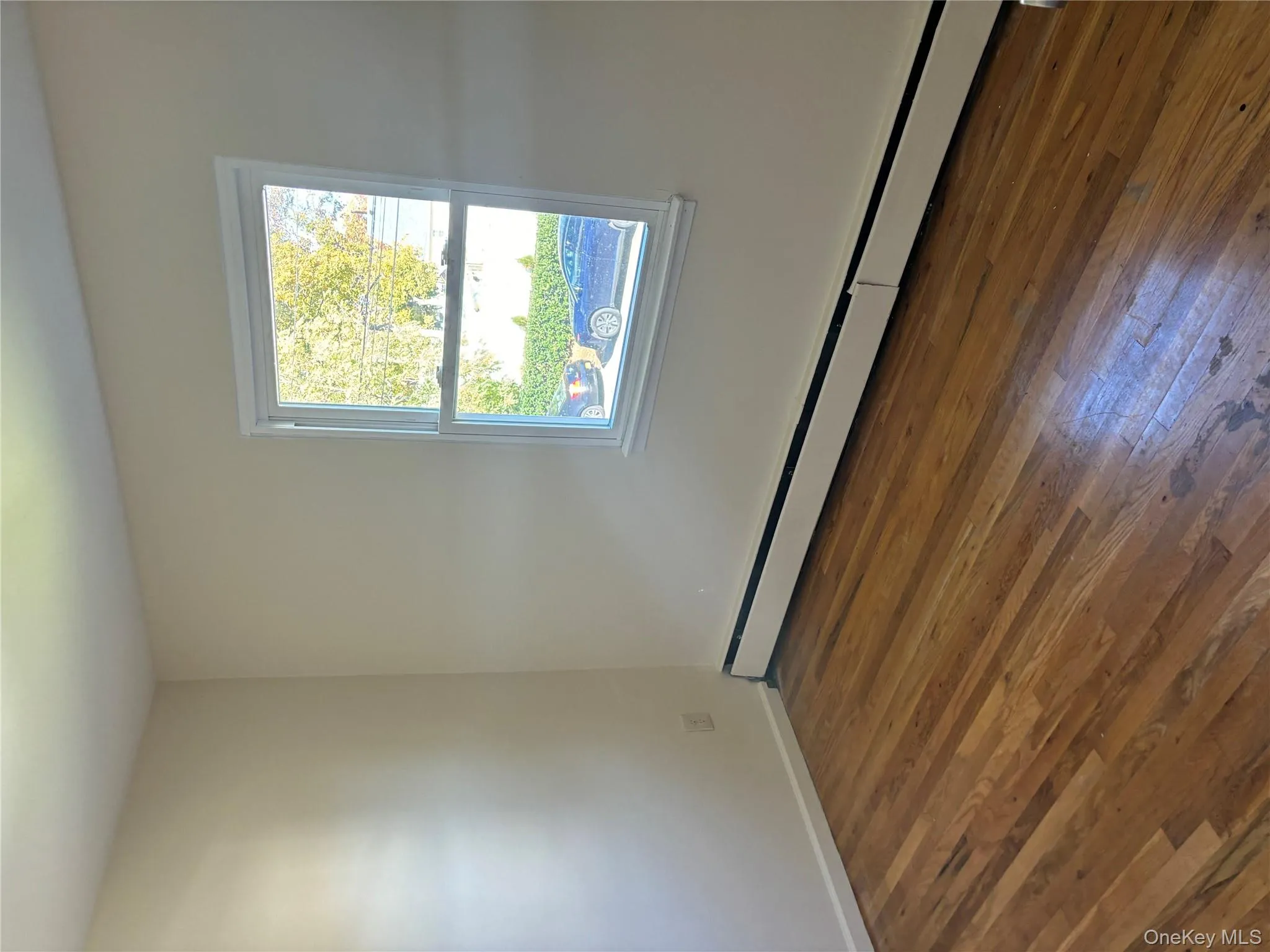 Spare room with baseboard heating and dark wood finished floors Spare room with baseboard heating and dark wood finished floors