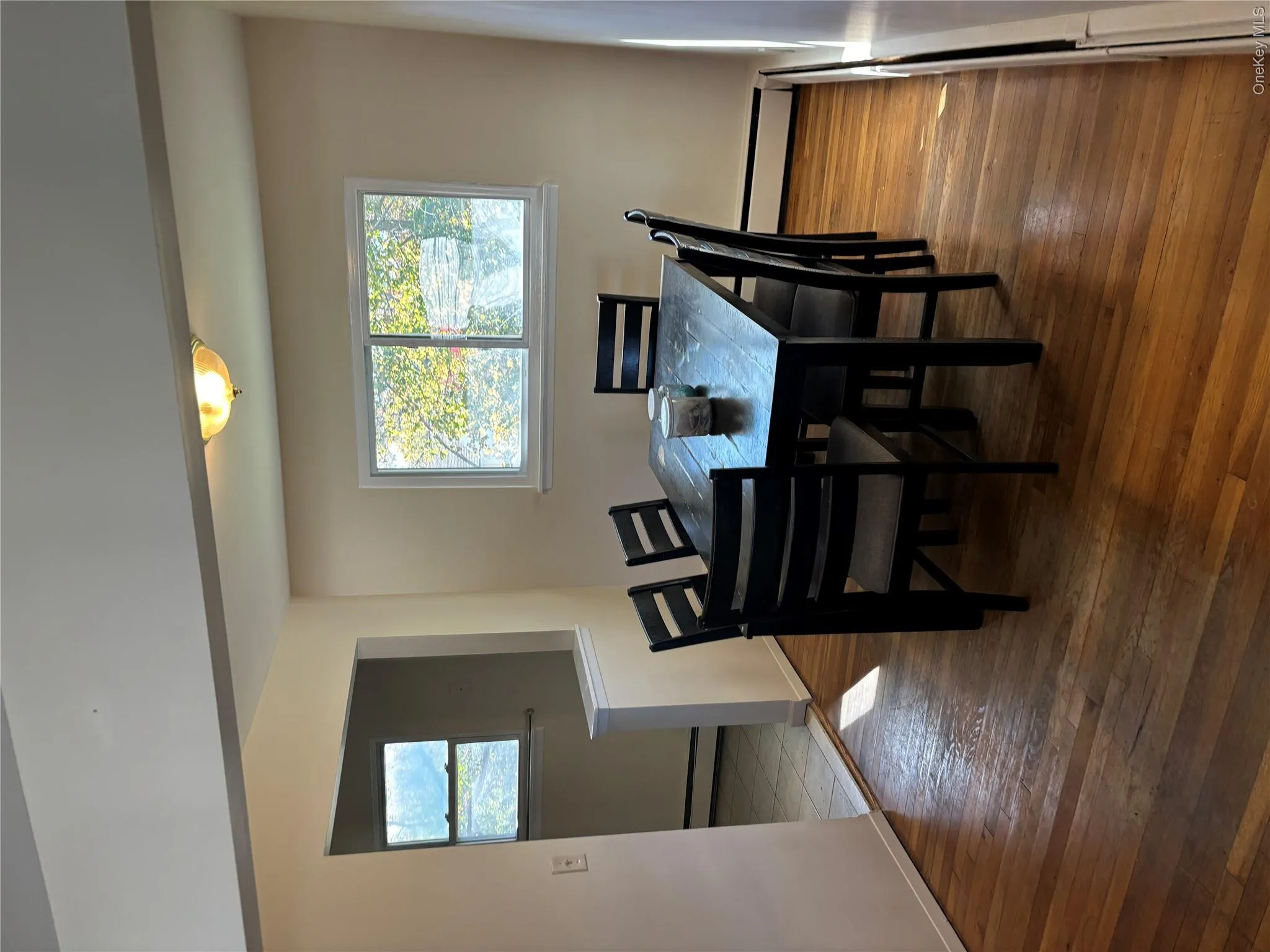 Dining room featuring healthy amount of natural light, a baseboard radiator, and dark wood-style floors Dining room featuring healthy amount of natural light, a baseboard radiator, and dark wood-style floors