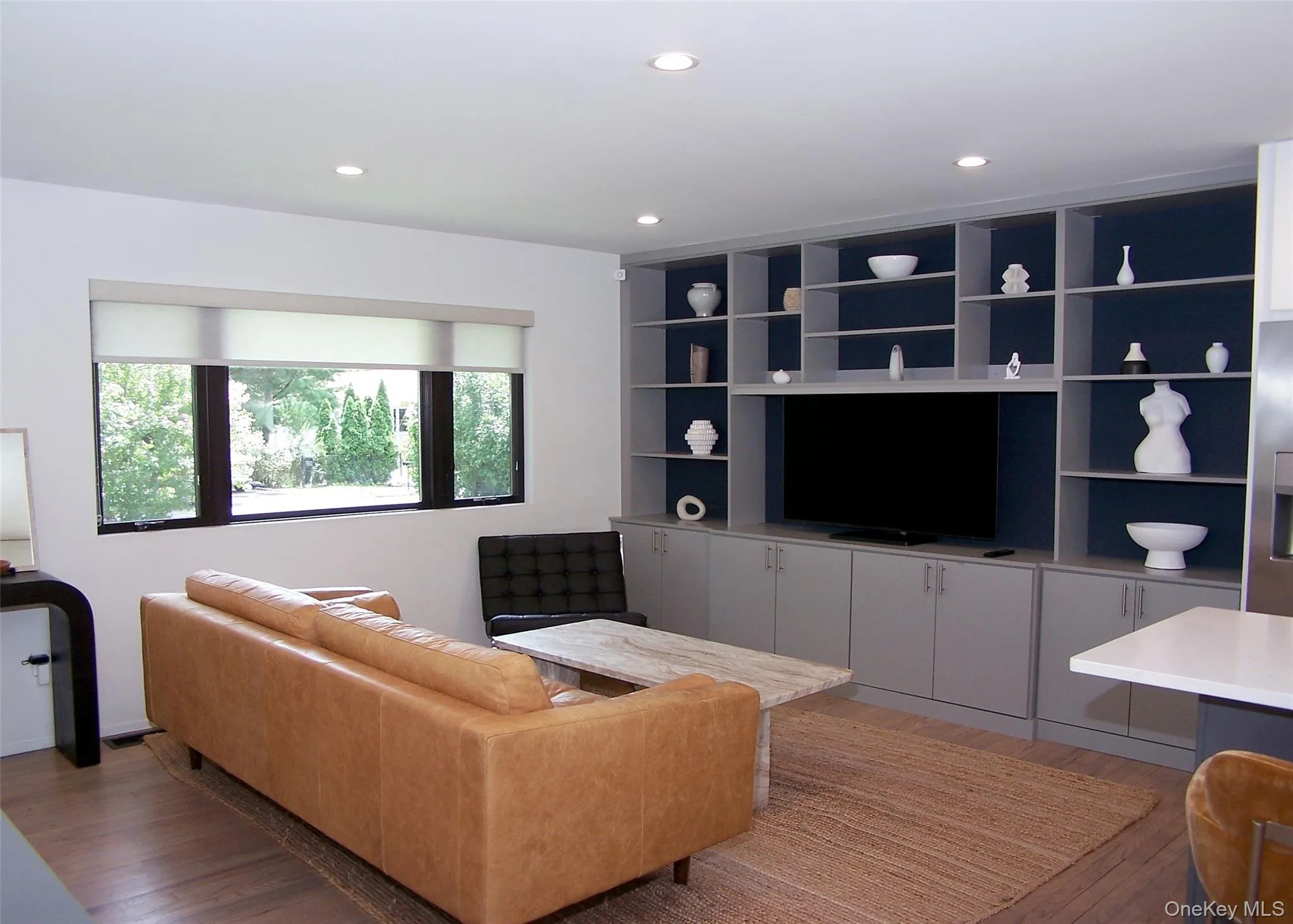 Living room with light wood-type flooring and recessed lighting Living room with light wood-type flooring and recessed lighting
