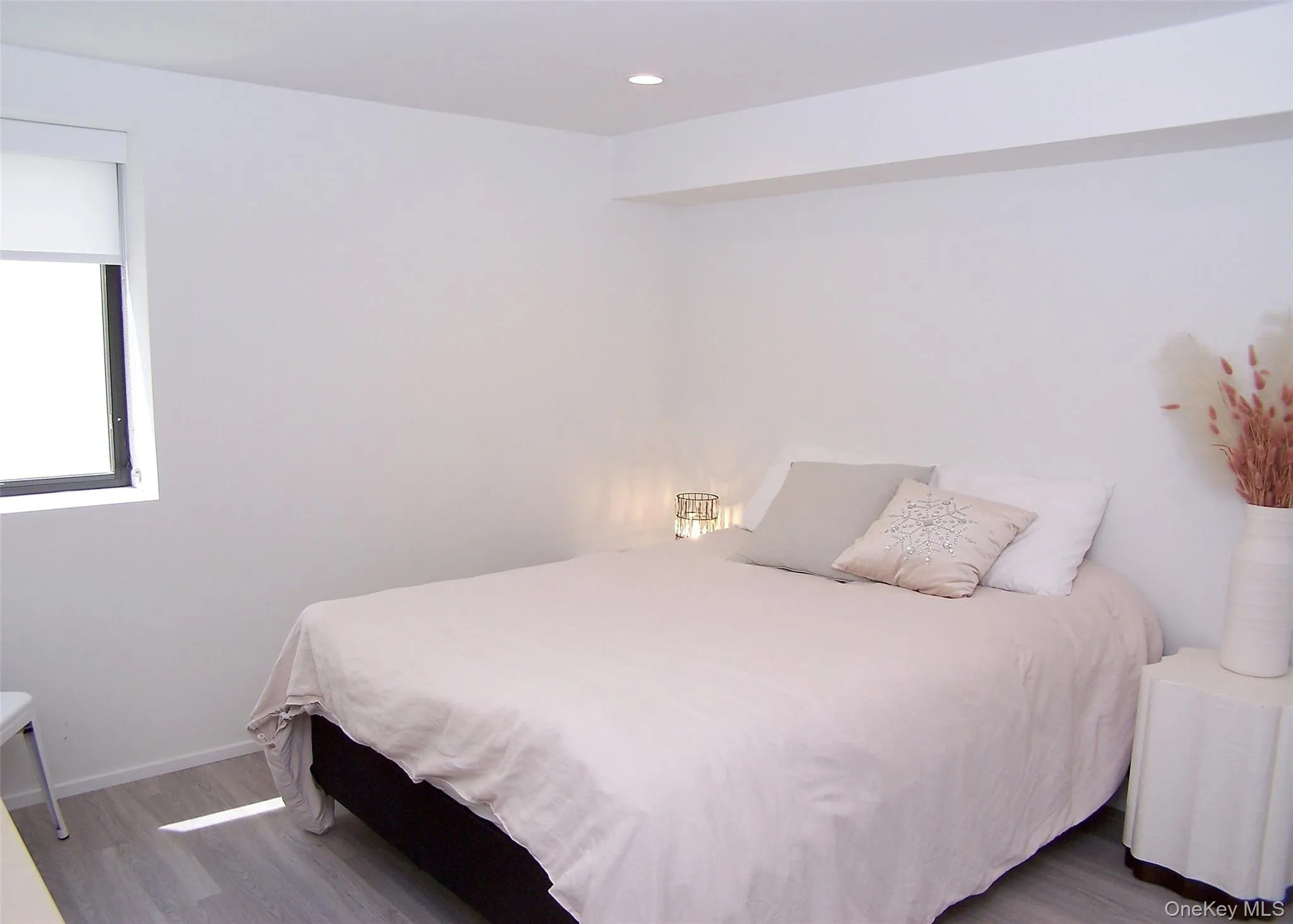 Bedroom with wood finished floors and recessed lighting Bedroom with wood finished floors and recessed lighting