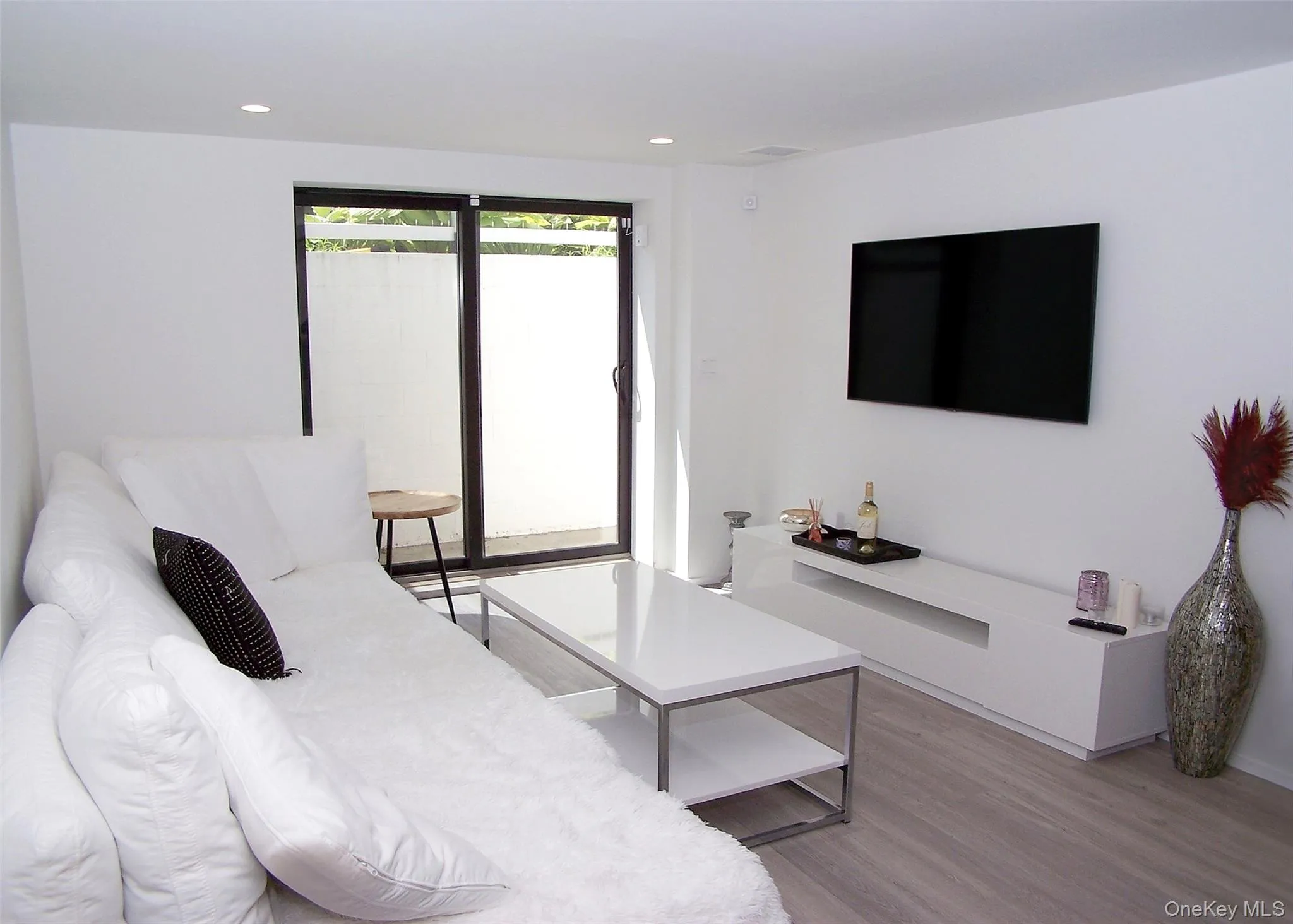 Bedroom featuring light wood finished floors and recessed lighting Bedroom featuring light wood finished floors and recessed lighting
