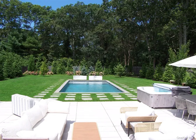 Swimming pool with a yard, outdoor lounge area, and a patio area