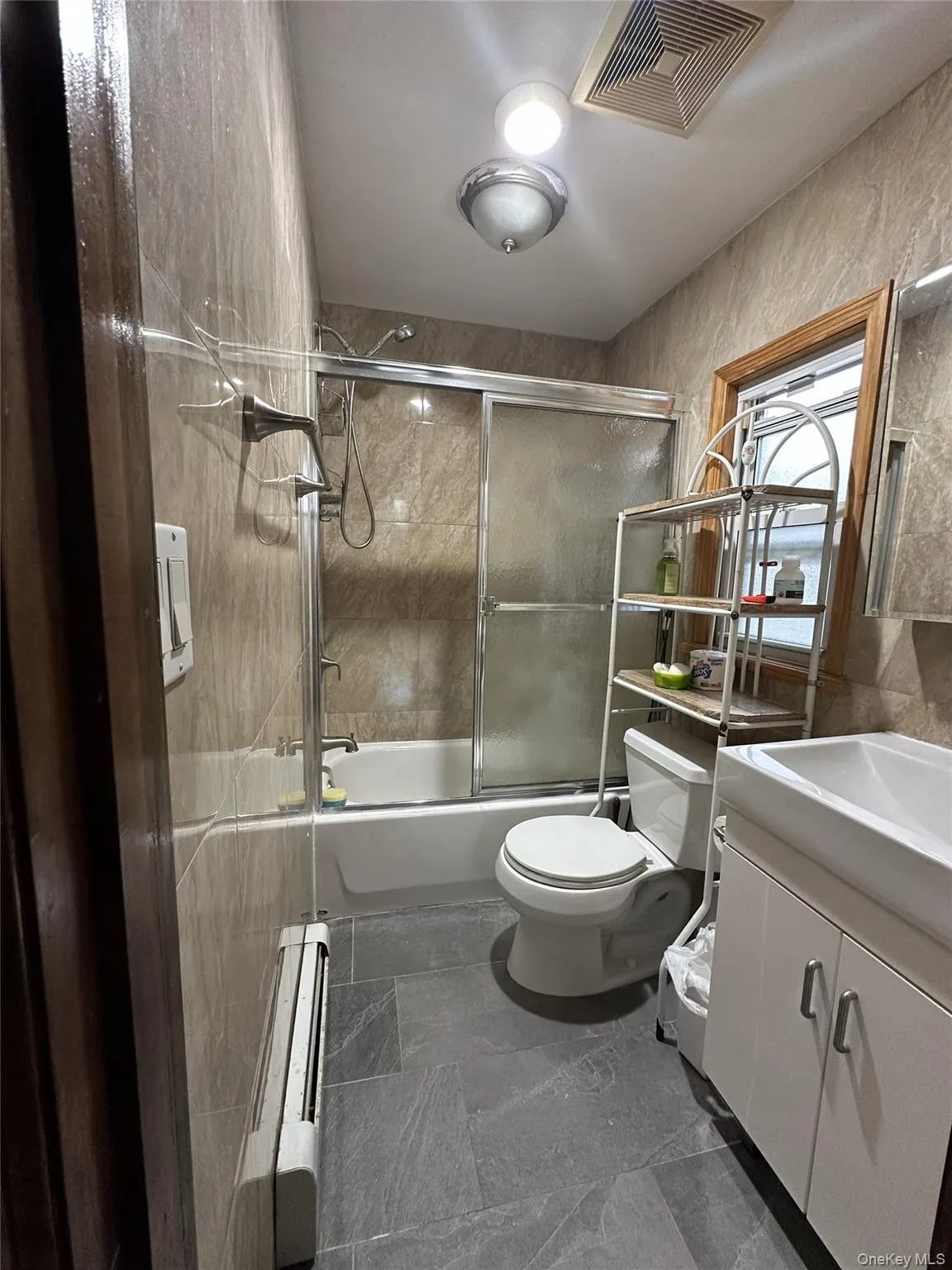 Bathroom with vanity and shower / bath combination with glass door Bathroom with vanity and shower / bath combination with glass door