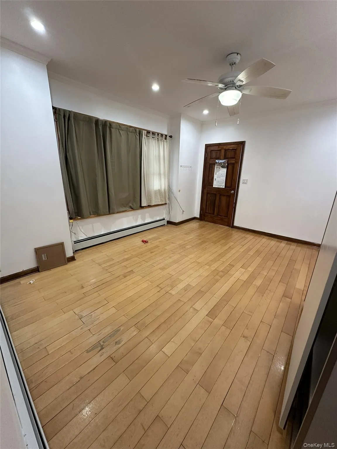 Foyer entrance featuring a baseboard radiator, recessed lighting, light wood-type flooring, and a ceiling fan Foyer entrance featuring a baseboard radiator, recessed lighting, light wood-type flooring, and a ceiling fan