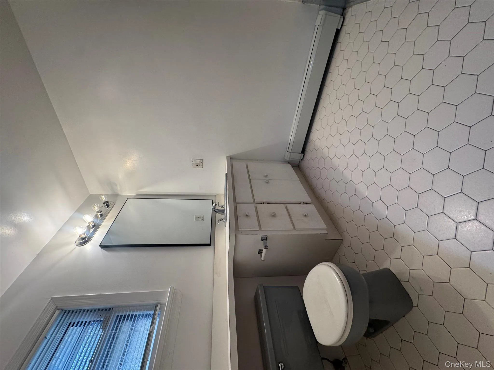 Bathroom with a baseboard heating unit and vanity Bathroom with a baseboard heating unit and vanity