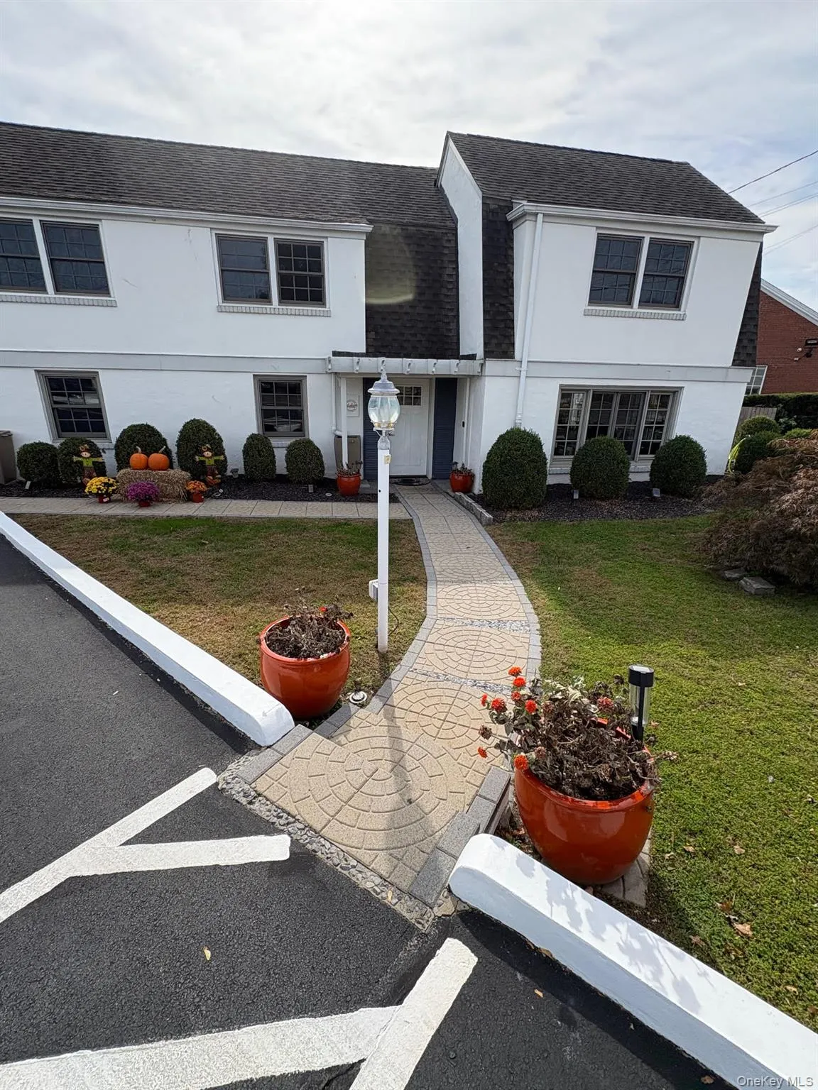 View of front of home with roof with shingles, a front lawn, and stucco siding View of front of home with roof with shingles, a front lawn, and stucco siding