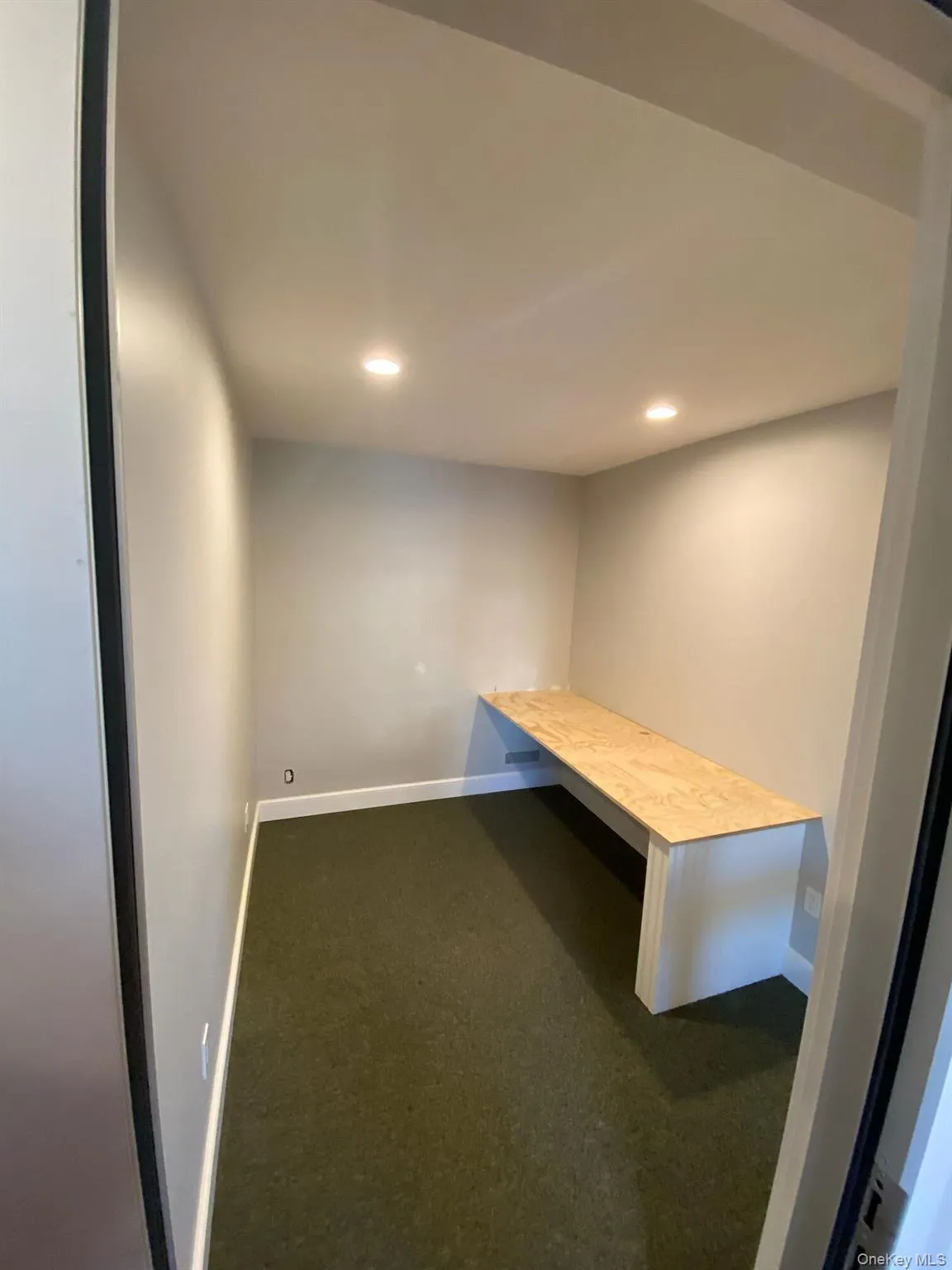 Unfurnished office featuring recessed lighting and dark colored carpet Unfurnished office featuring recessed lighting and dark colored carpet