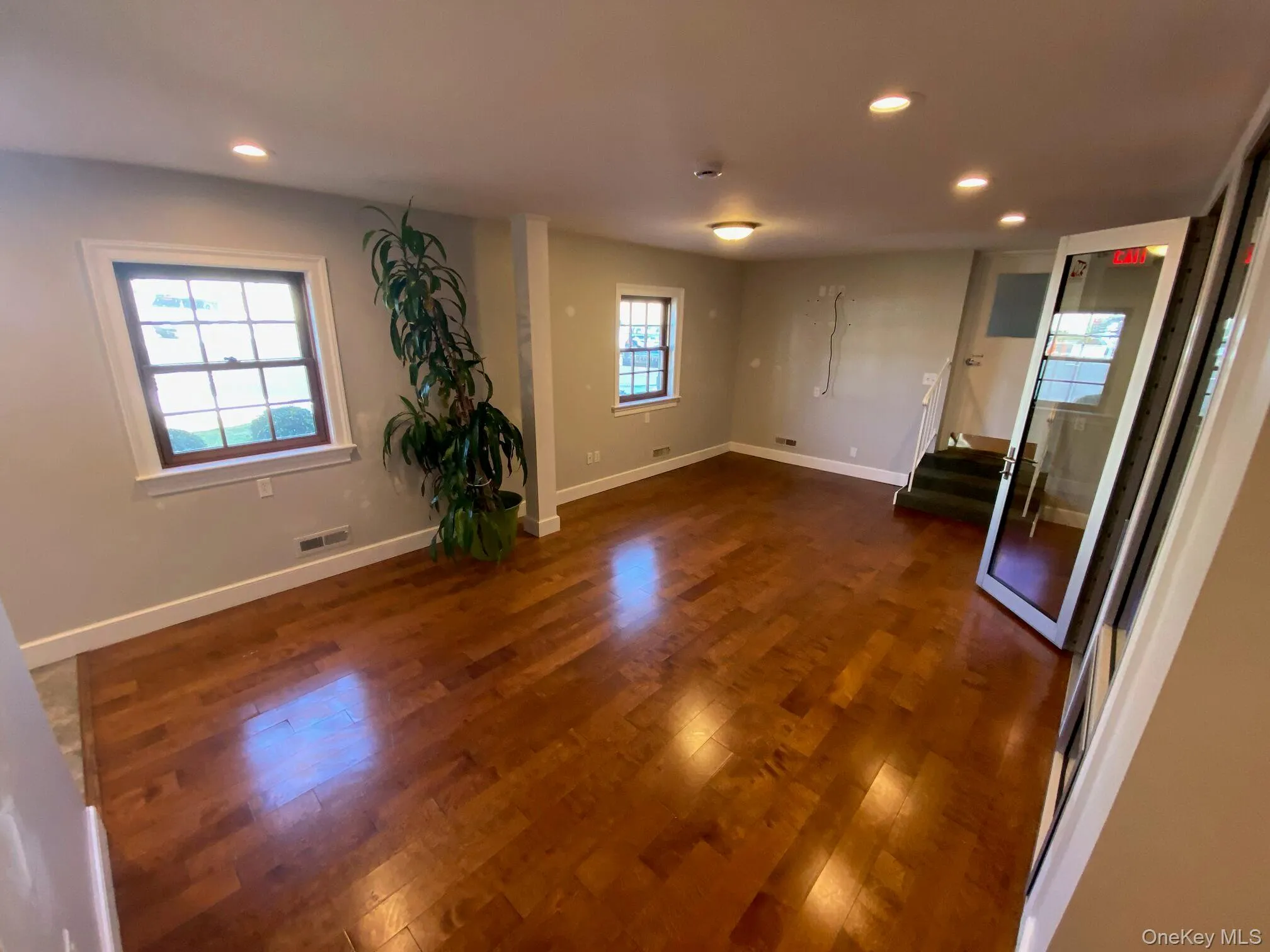 Spare room with dark wood-type flooring and recessed lighting Spare room with dark wood-type flooring and recessed lighting