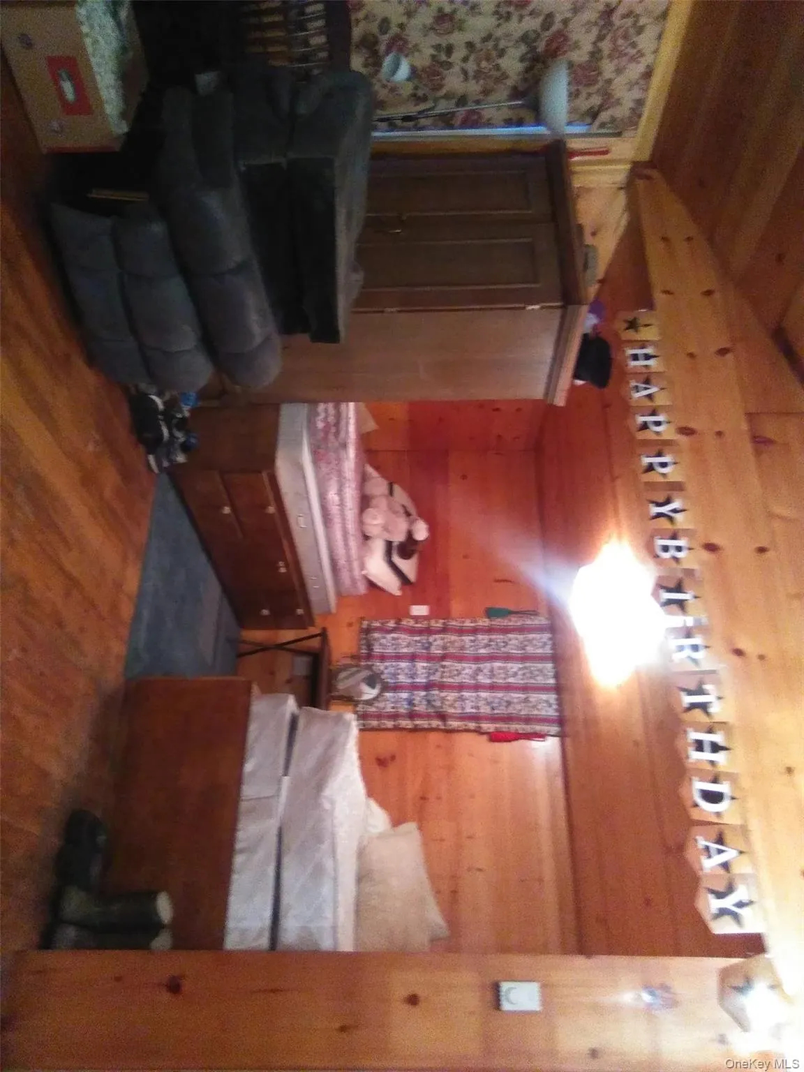 Bedroom featuring wood walls, dark wood-style flooring, wooden ceiling, and lofted ceiling Bedroom featuring wood walls, dark wood-style flooring, wooden ceiling, and lofted ceiling