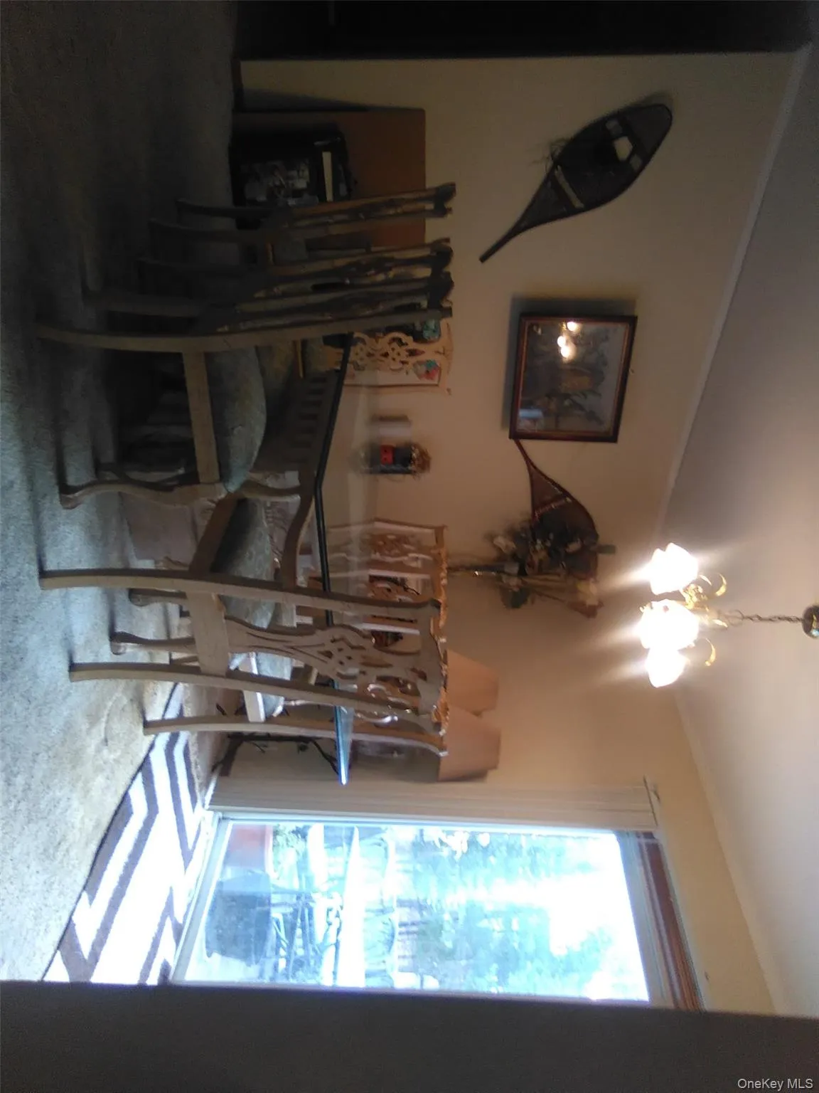 Dining area featuring a chandelier, carpet floors, and crown molding Dining area featuring a chandelier, carpet floors, and crown molding