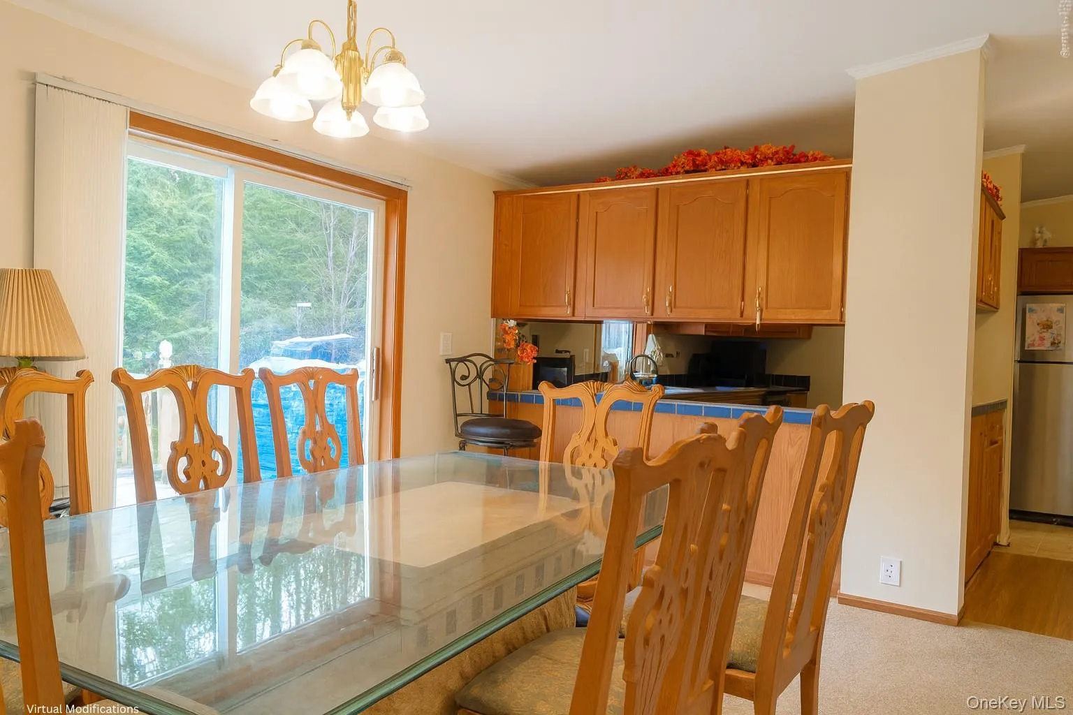 Dining area featuring a chandelier and light carpet Dining area featuring a chandelier and light carpet
