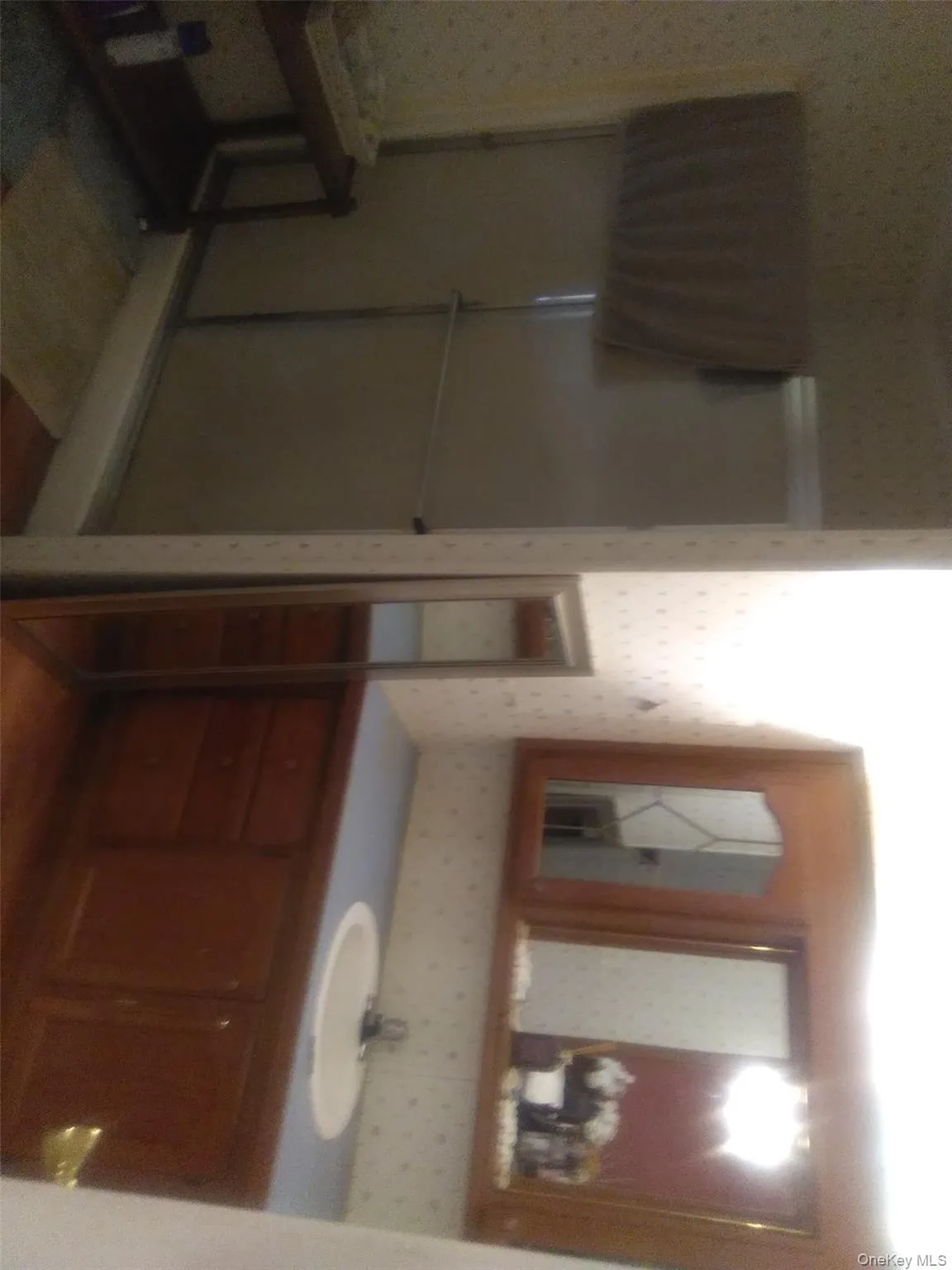 Full bathroom with wallpapered walls, vanity, and a stall shower Full bathroom with wallpapered walls, vanity, and a stall shower