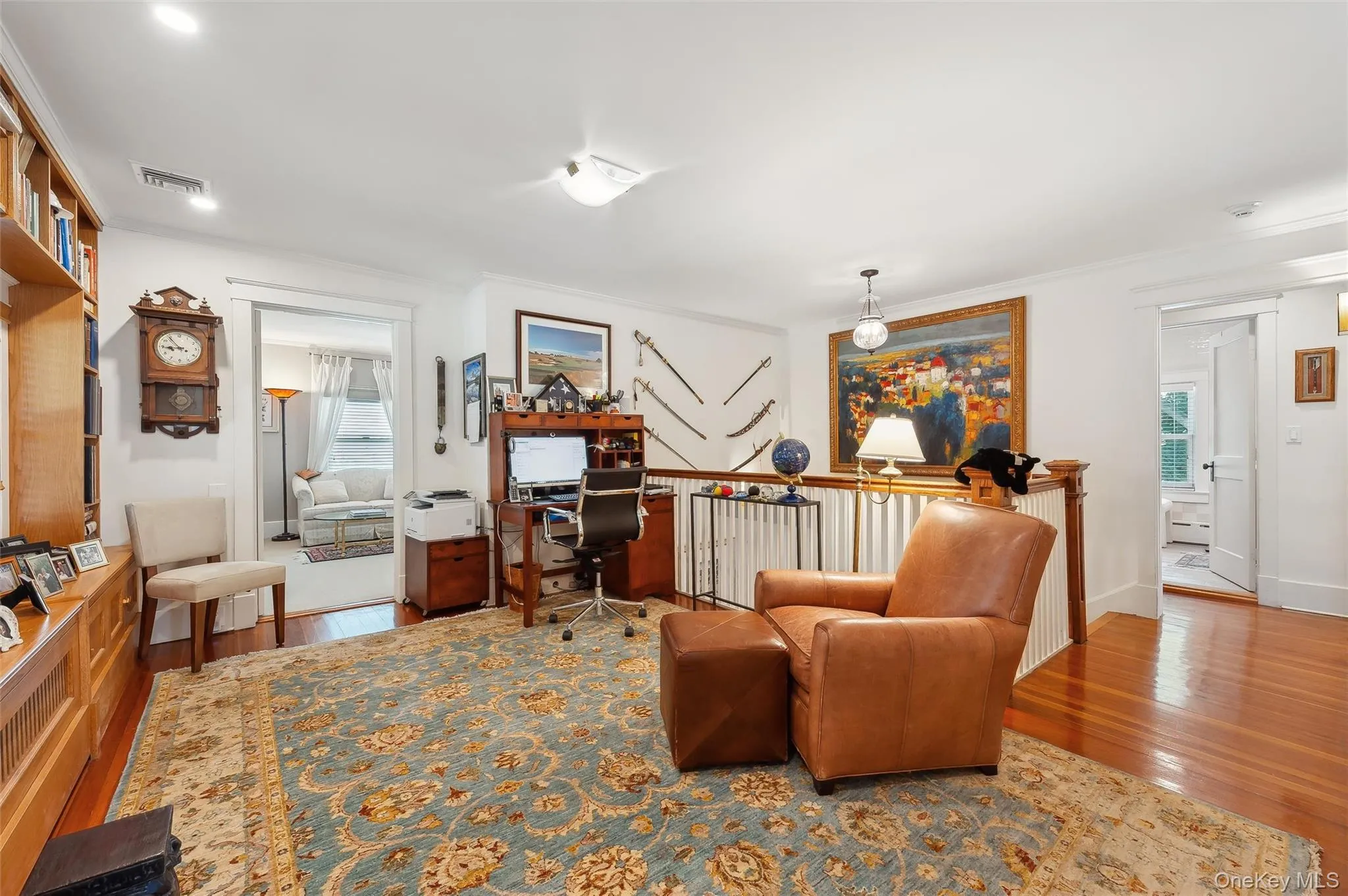 Office area with wood finished floors, plenty of natural light, and ornamental molding Office area with wood finished floors, plenty of natural light, and ornamental molding