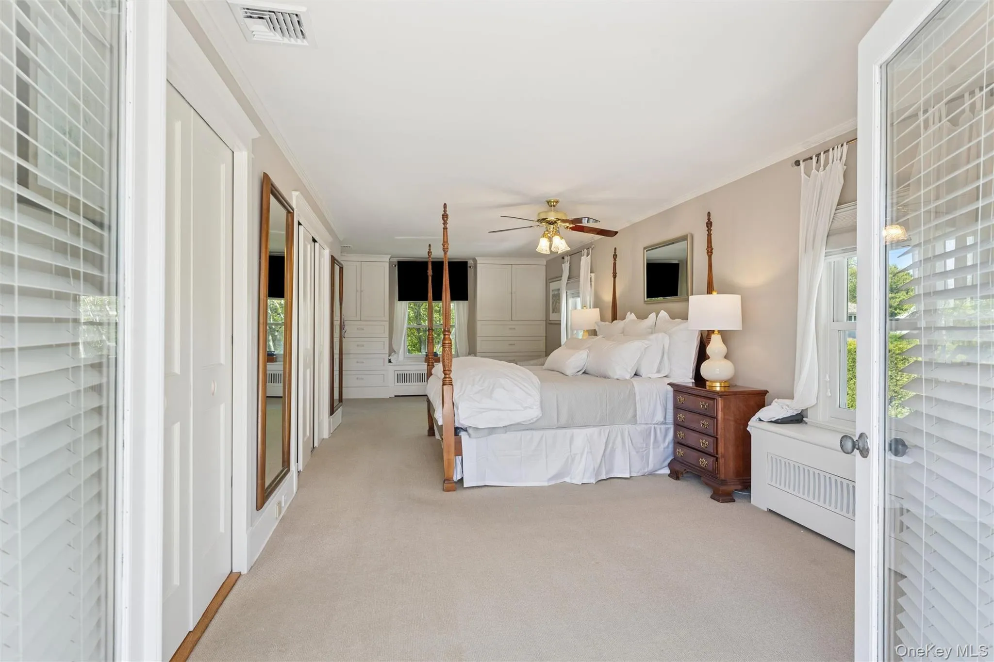 Bedroom with access to exterior, light colored carpet, ornamental molding, and ceiling fan Bedroom with access to exterior, light colored carpet, ornamental molding, and ceiling fan