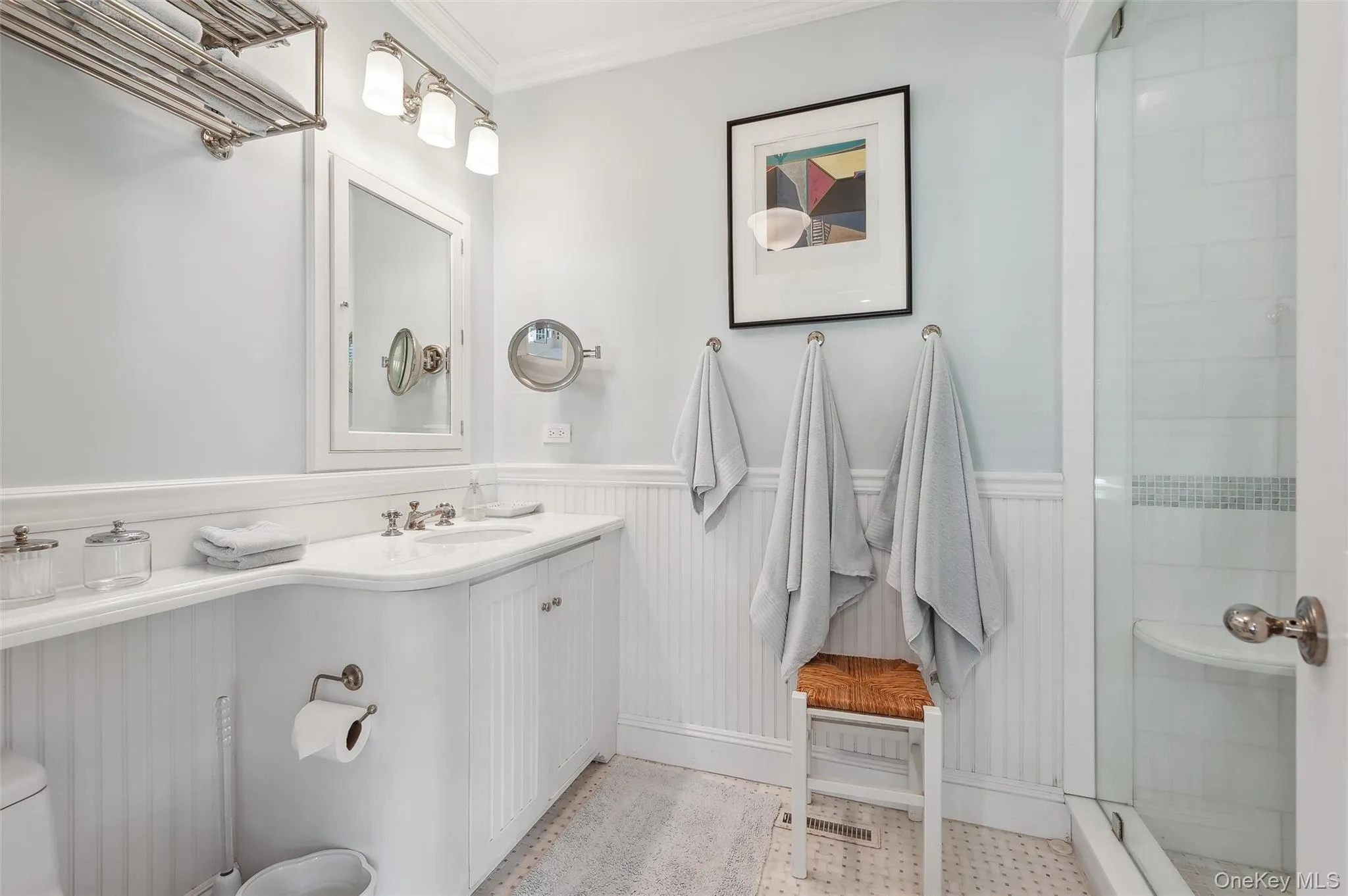 Full bathroom with crown molding, wainscoting, a shower stall, and vanity Full bathroom with crown molding, wainscoting, a shower stall, and vanity