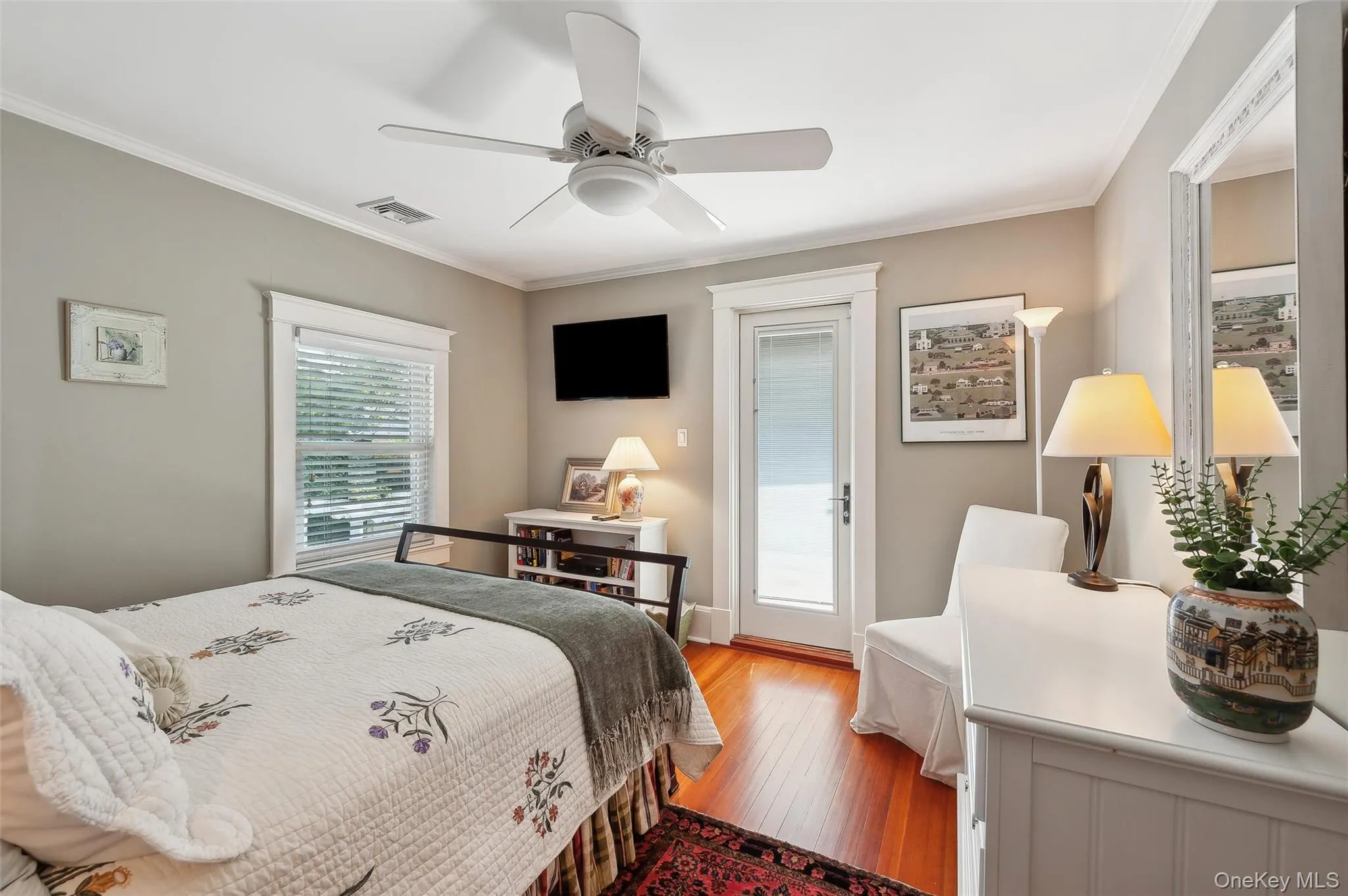 Bedroom featuring hardwood / wood-style flooring, ornamental molding, a ceiling fan, and access to outside Bedroom featuring hardwood / wood-style flooring, ornamental molding, a ceiling fan, and access to outside