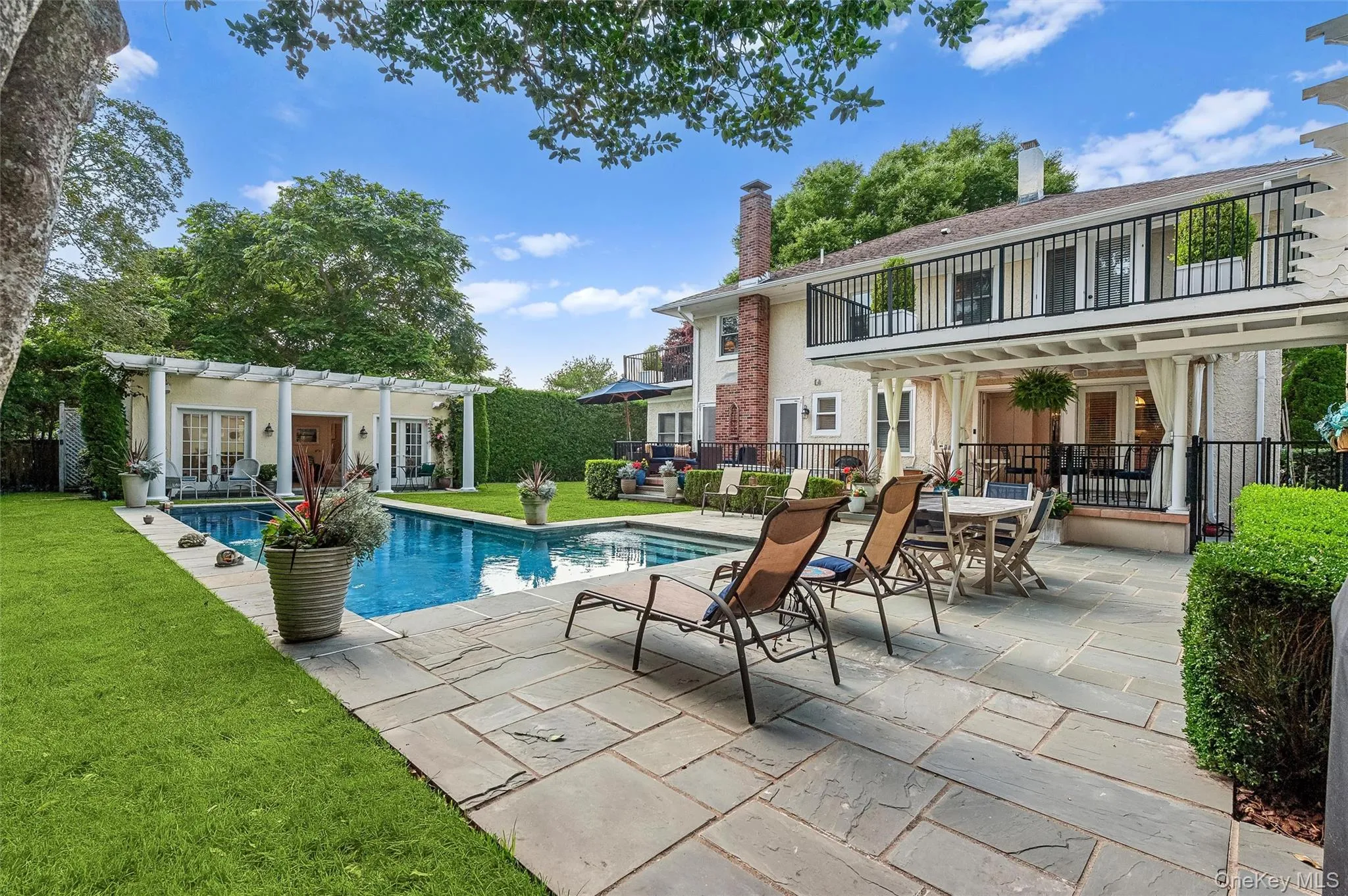 View of pool featuring french doors, a patio area, an exterior structure, an outbuilding, and a balcony View of pool featuring french doors, a patio area, an exterior structure, an outbuilding, and a balcony