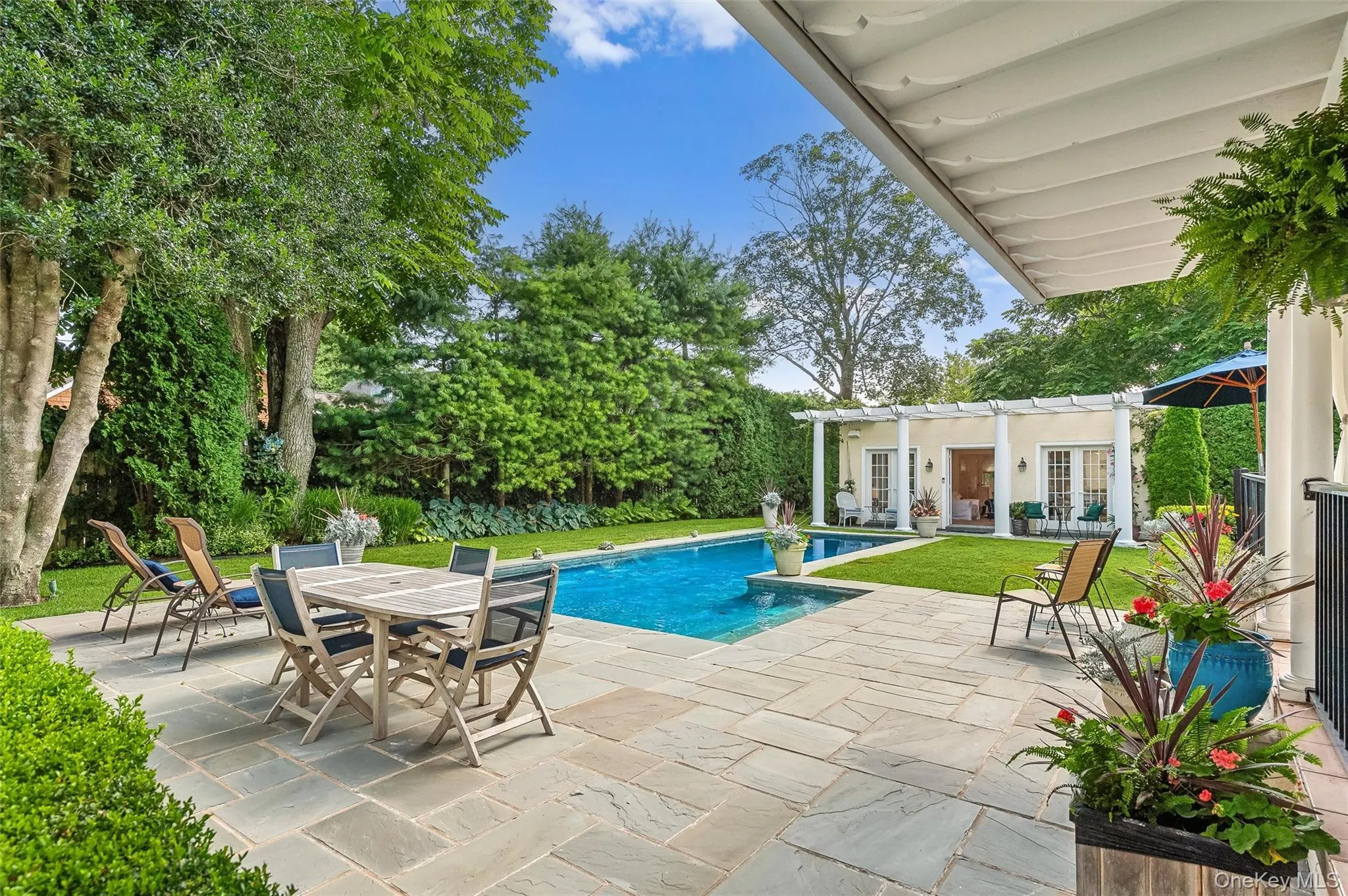 Swimming pool with a patio area, a storage structure, french doors, an outbuilding, and outdoor dining area Swimming pool with a patio area, a storage structure, french doors, an outbuilding, and outdoor dining area