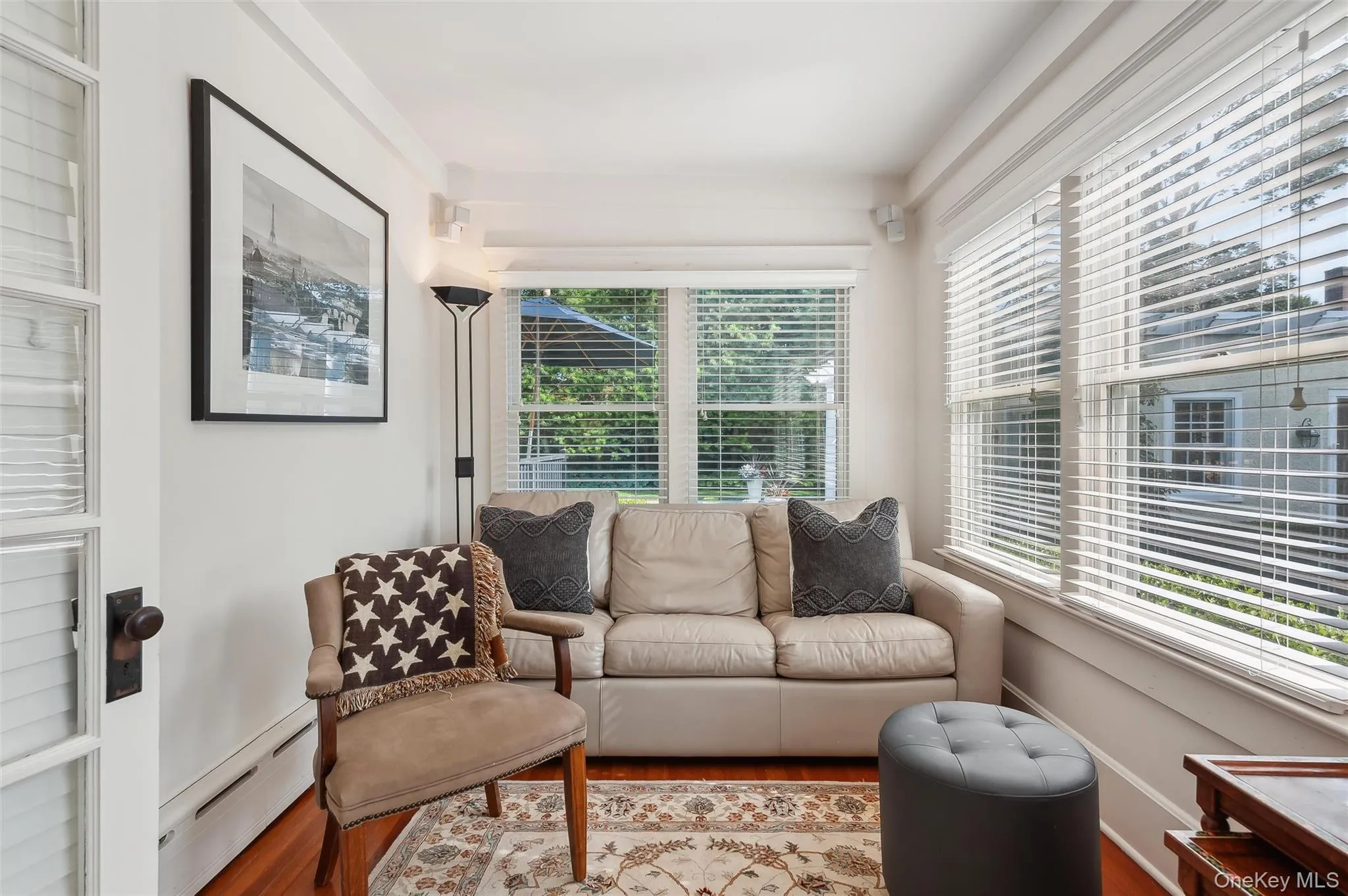 Living area with baseboard heating and wood finished floors Living area with baseboard heating and wood finished floors