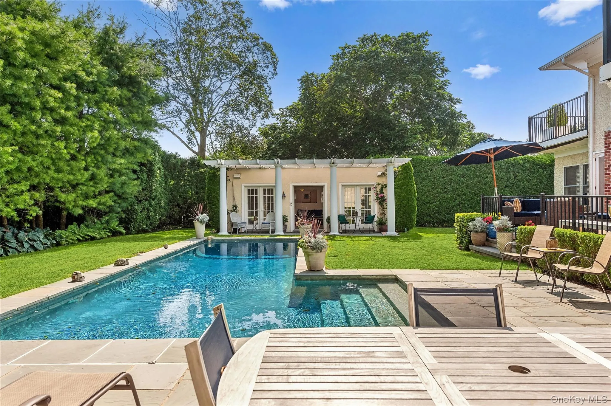Outdoor pool with a yard, a patio, a storage structure, an outdoor structure, and french doors Outdoor pool with a yard, a patio, a storage structure, an outdoor structure, and french doors
