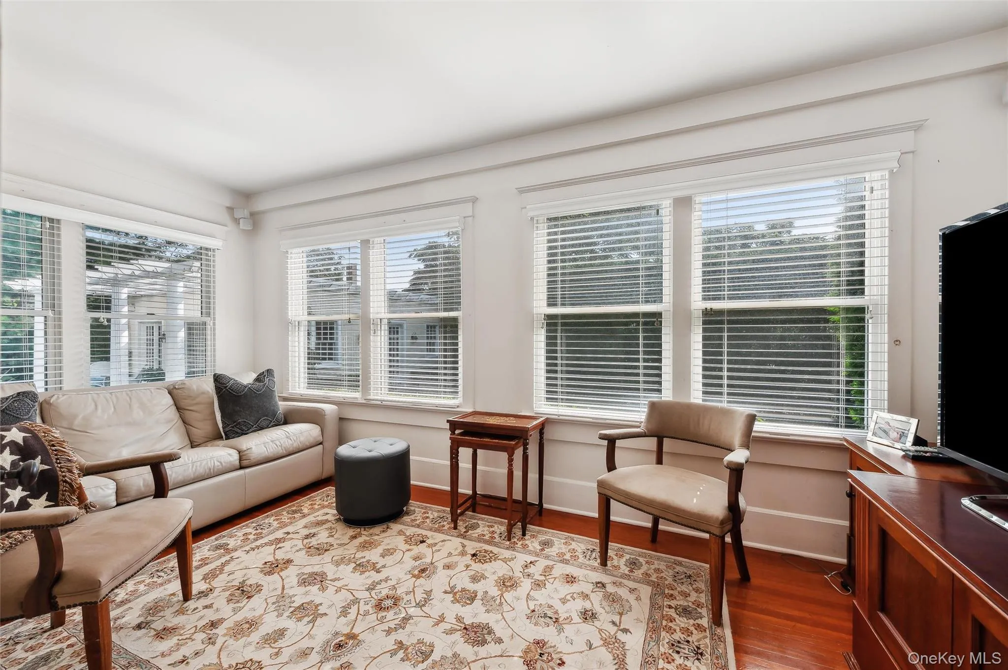 Living area with light wood-style flooring and baseboards Living area with light wood-style flooring and baseboards