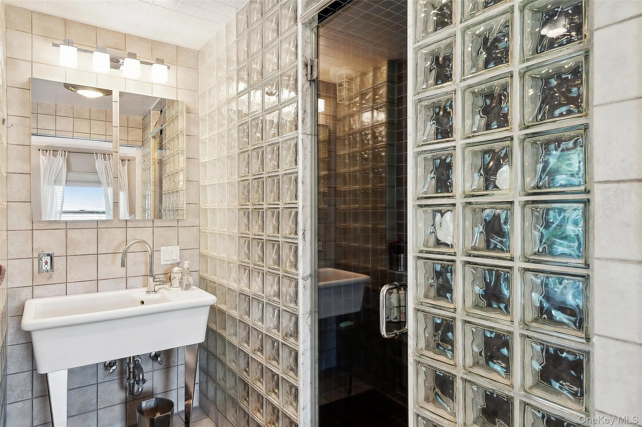 Bathroom featuring tile walls and a stall shower Bathroom featuring tile walls and a stall shower