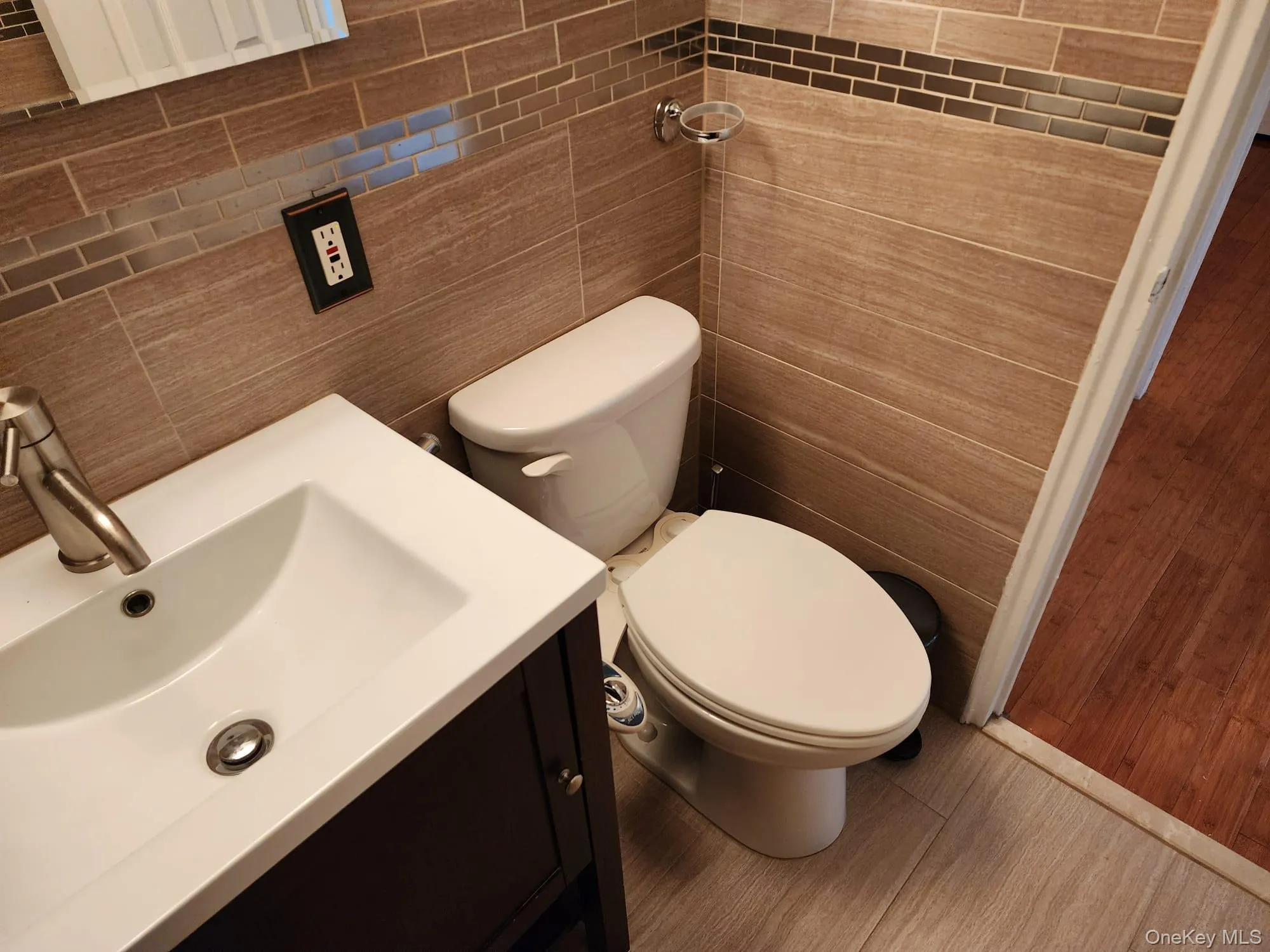 Bathroom featuring vanity and tile walls Bathroom featuring vanity and tile walls