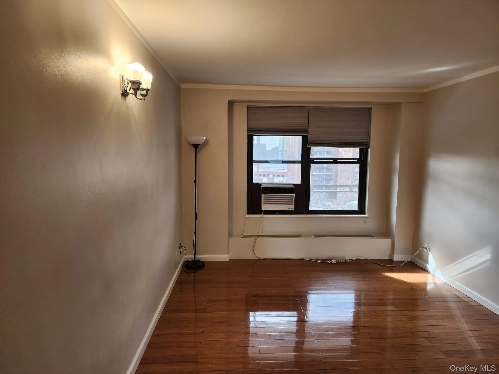 Unfurnished room with crown molding, hardwood / wood-style flooring, and cooling unit Unfurnished room with crown molding, hardwood / wood-style flooring, and cooling unit