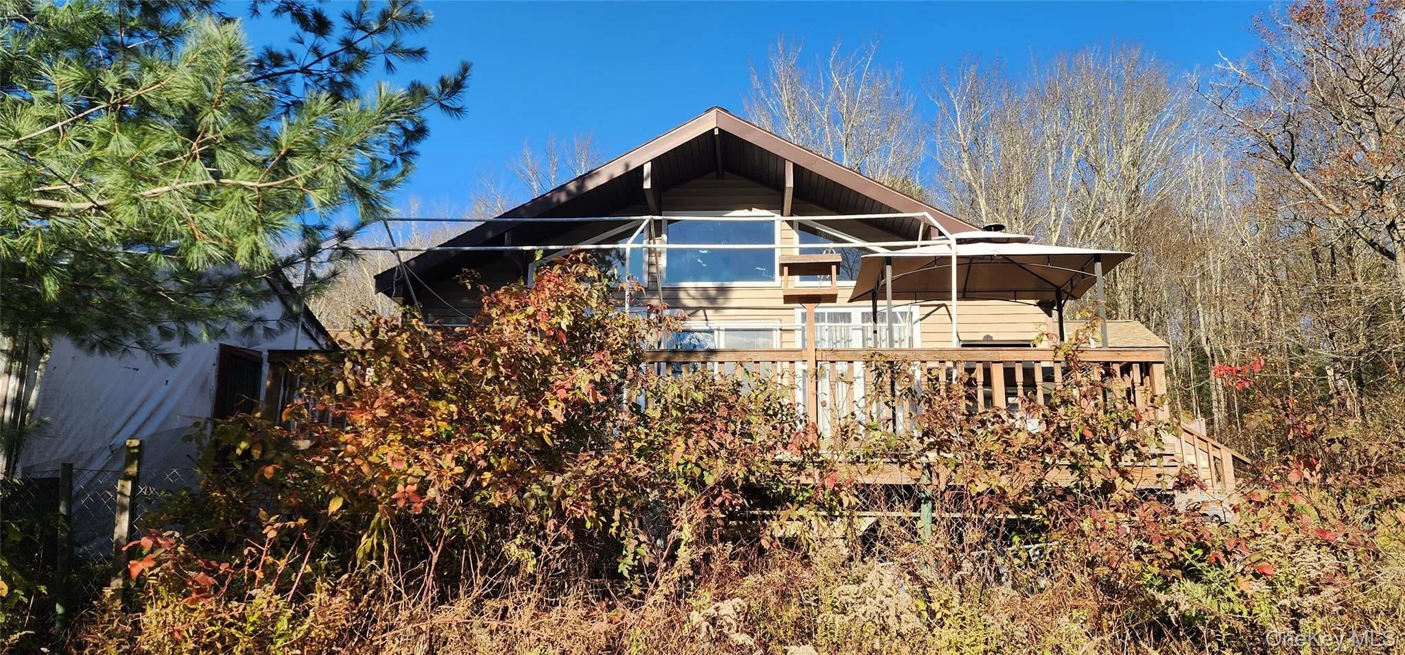 Rear view of house featuring a sunroom Rear view of house featuring a sunroom