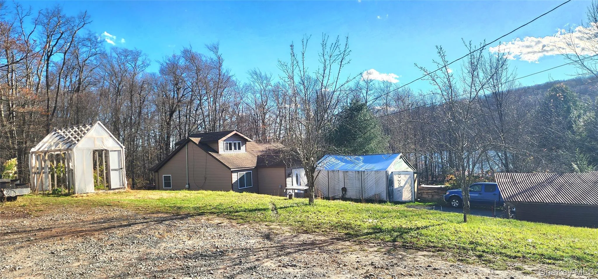 View of green lawn with an outbuilding View of green lawn with an outbuilding