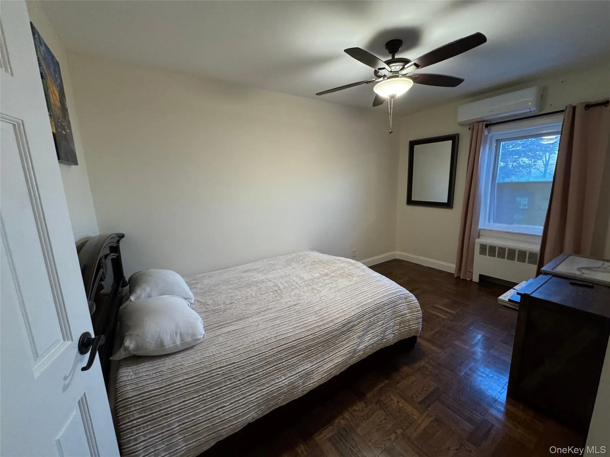 Bedroom featuring radiator and a ceiling fan Bedroom featuring radiator and a ceiling fan