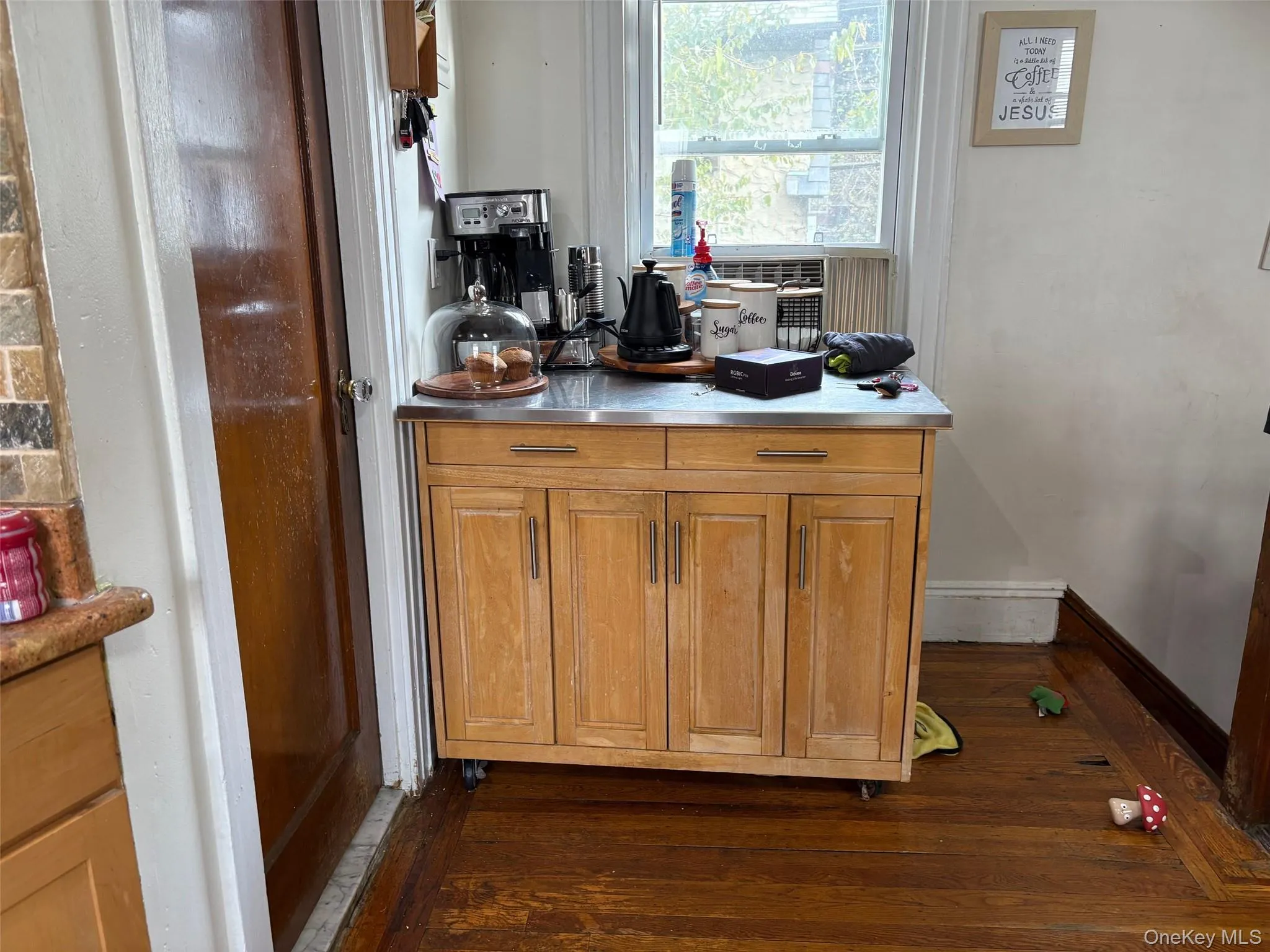 Bar area with dark wood-style flooring, brown cabinetry, stainless steel countertops, and cooling unit Bar area with dark wood-style flooring, brown cabinetry, stainless steel countertops, and cooling unit